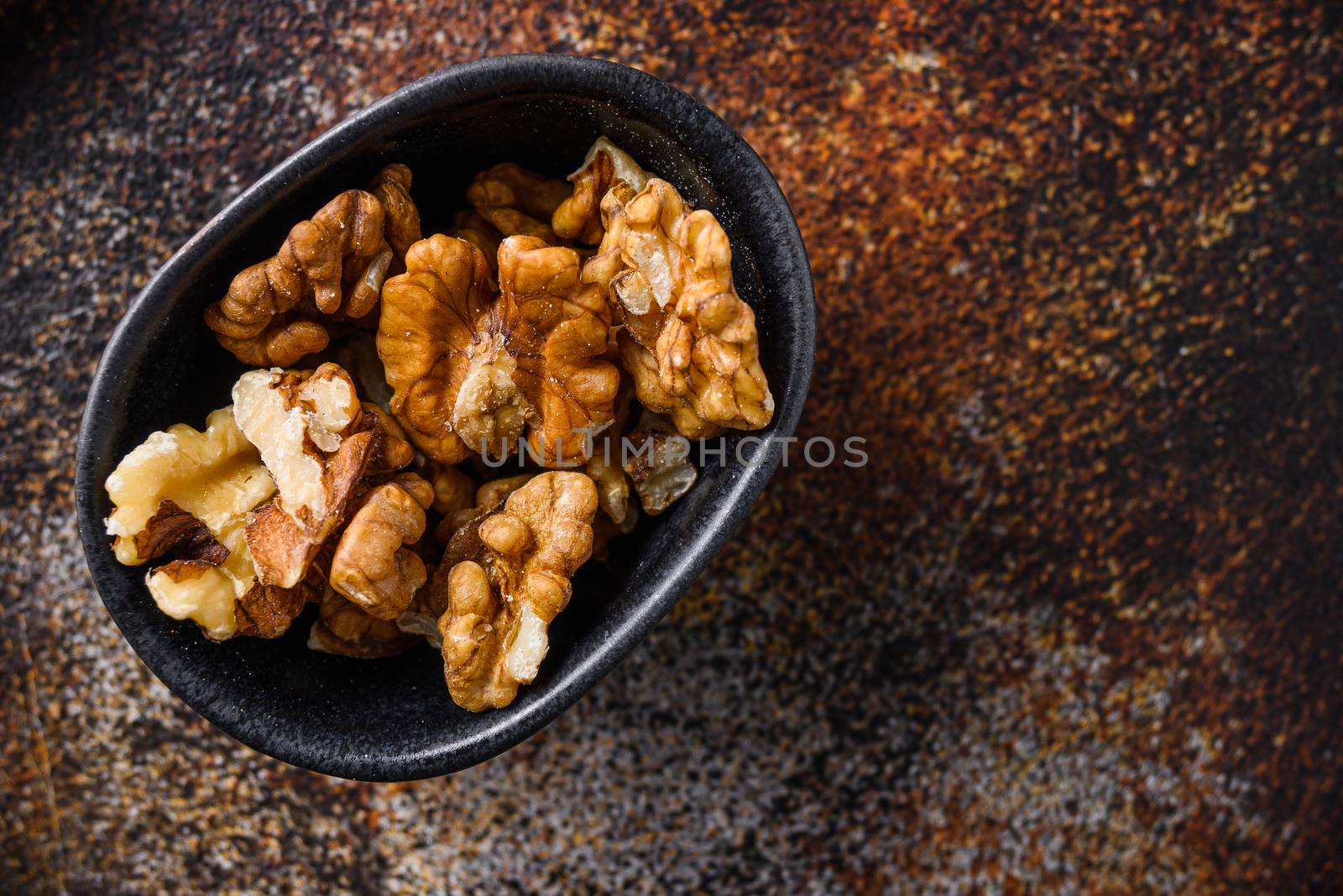 Walnuts nuts in black bowltop view space for text