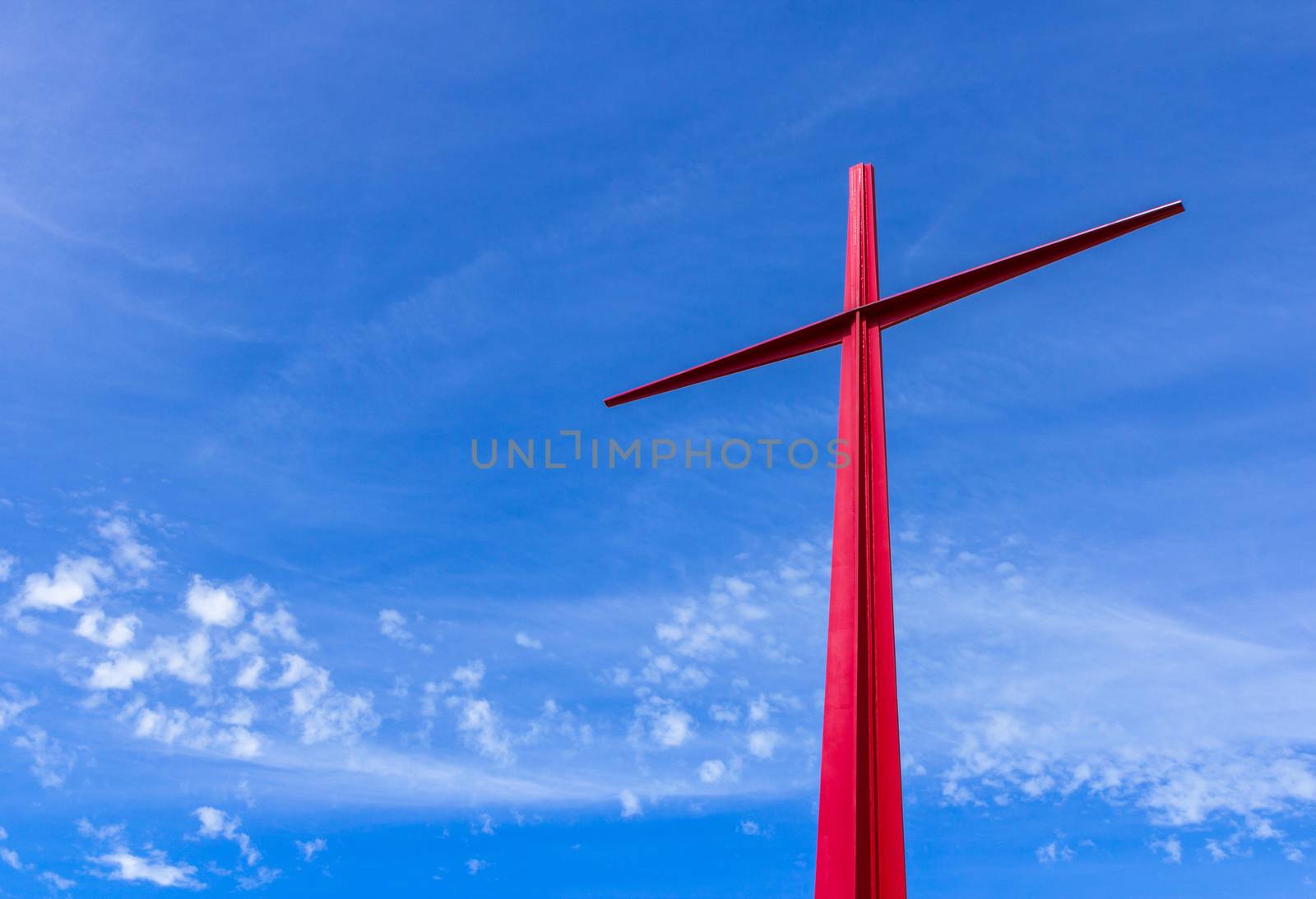 Large red christian cross on sky background. Passion symbology. Easter.