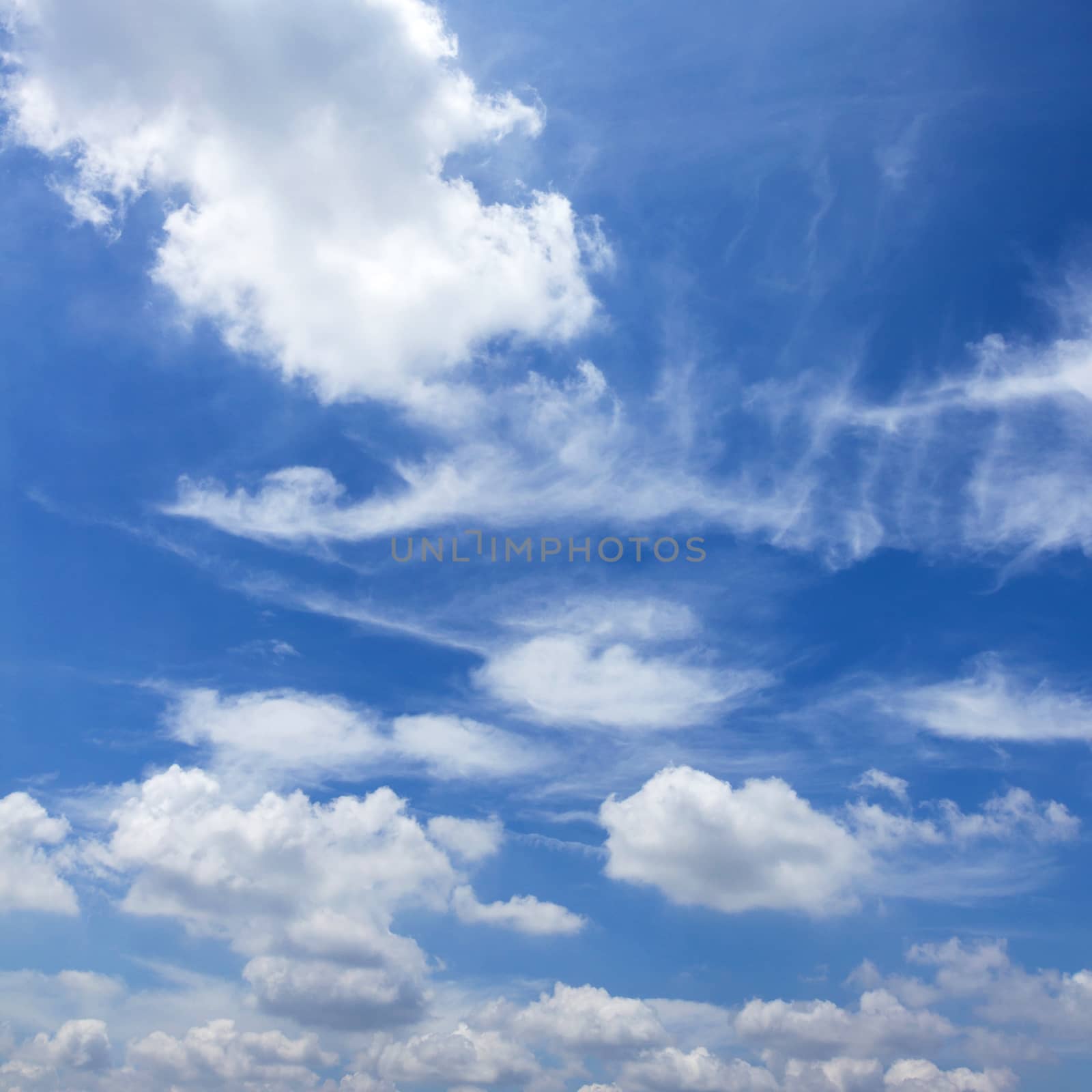 Blue sky background with tiny clouds