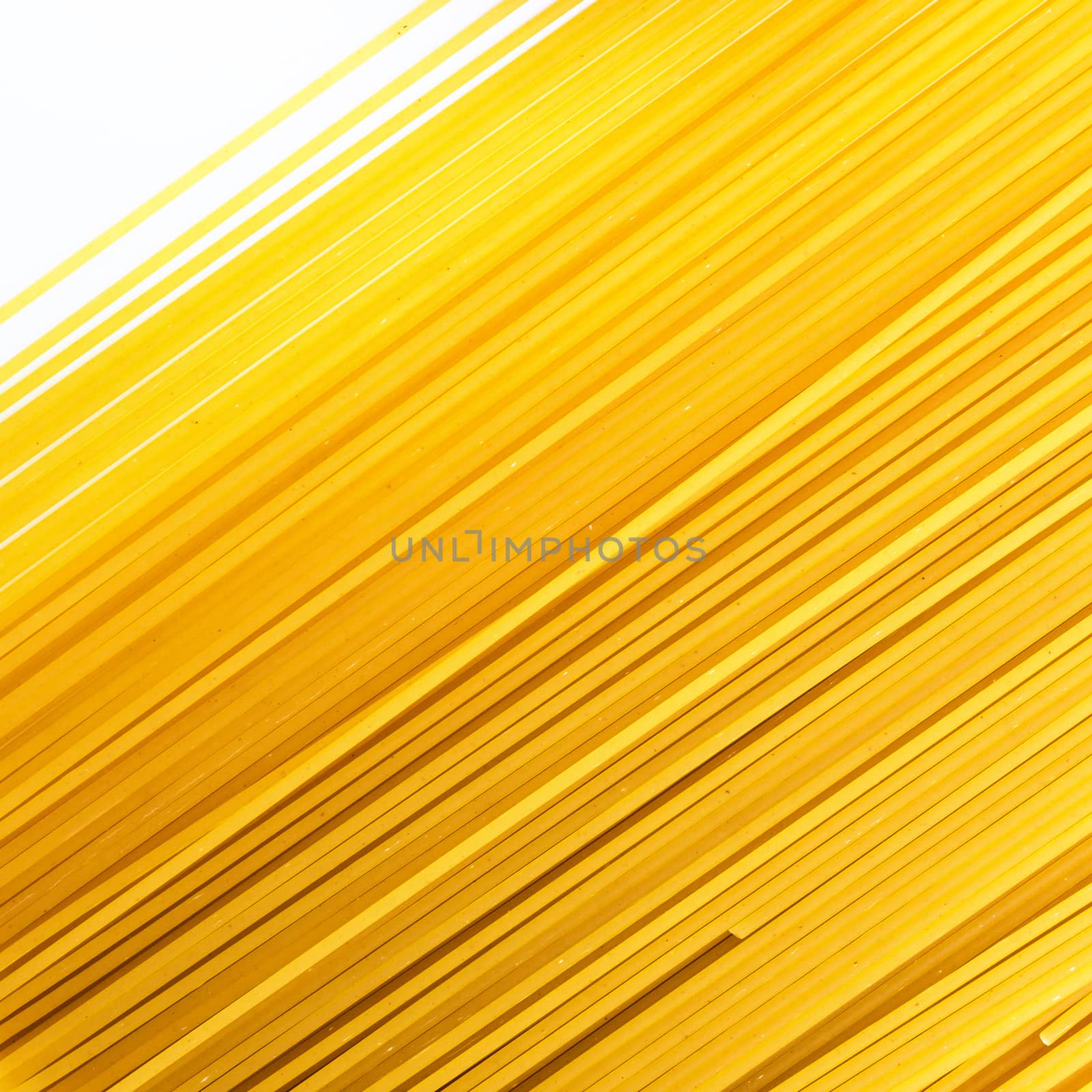 Uncooked spaghetti lie on a diagonal direction