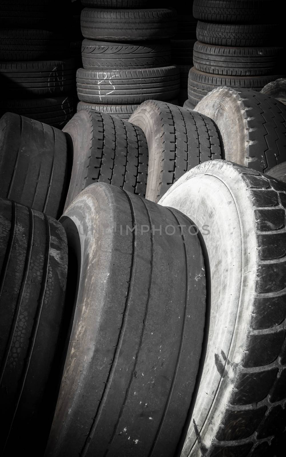 Old tires, stacked artfully, framed vertically.