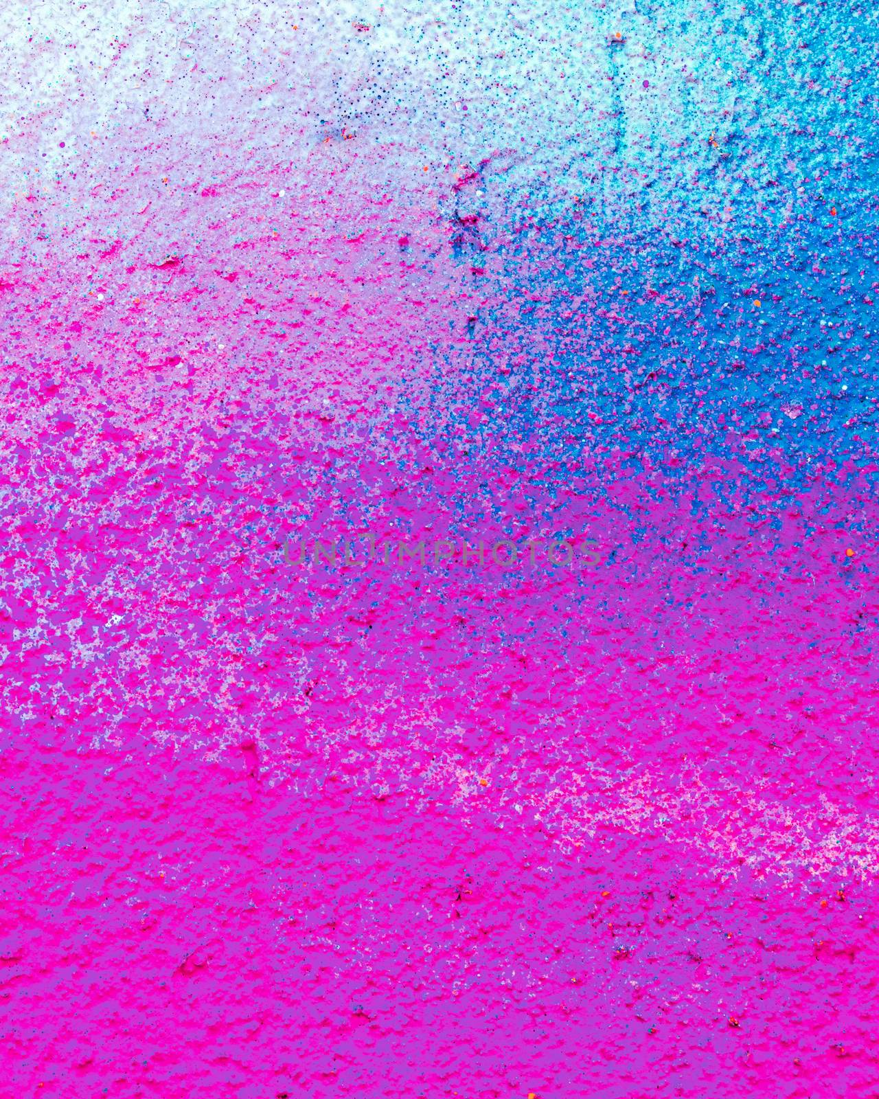 Fragment of colorful graffiti painted on a concrete wall. Bright pink or purple abstract background for design.