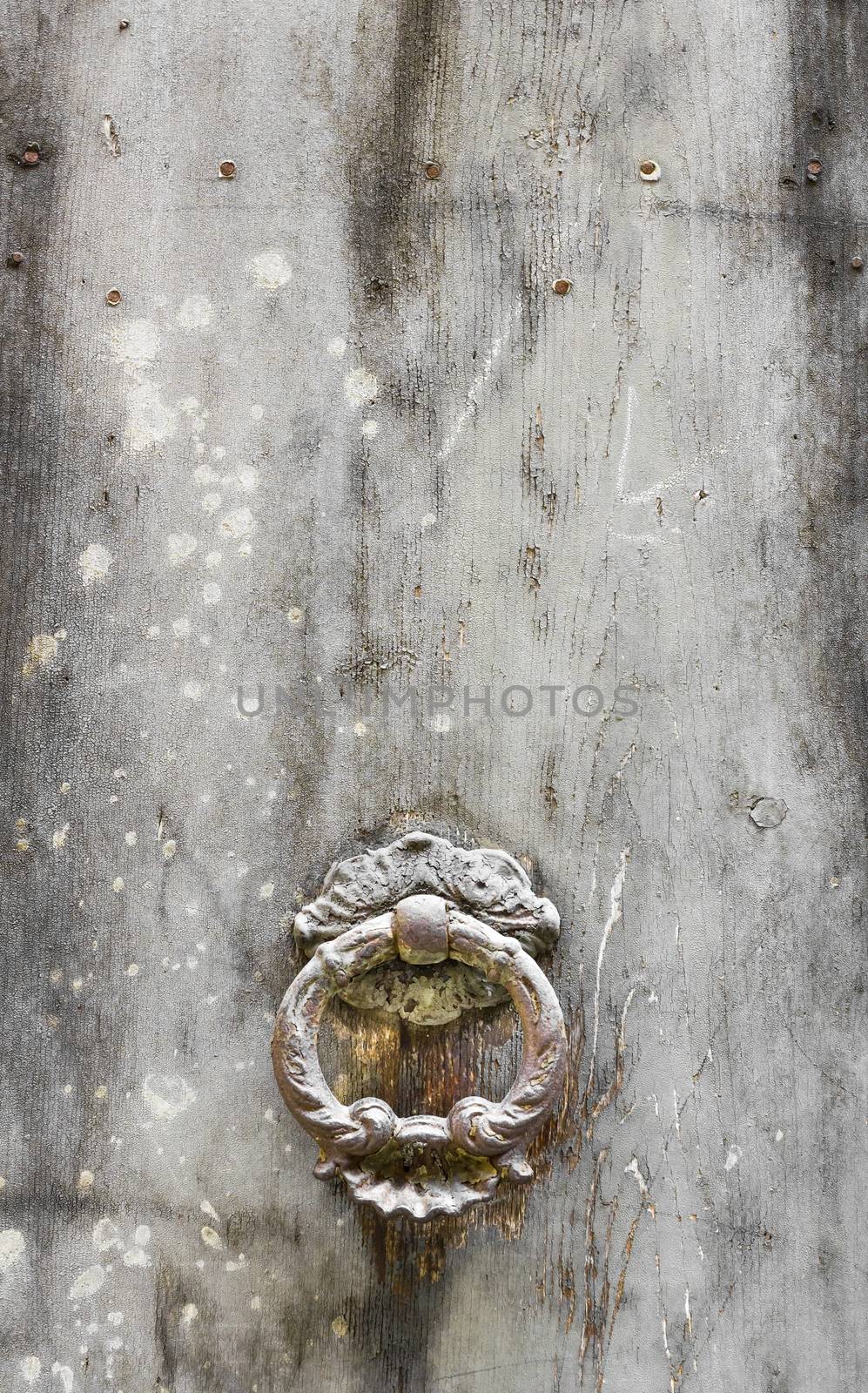 Ancient door knocker on white vintage background.