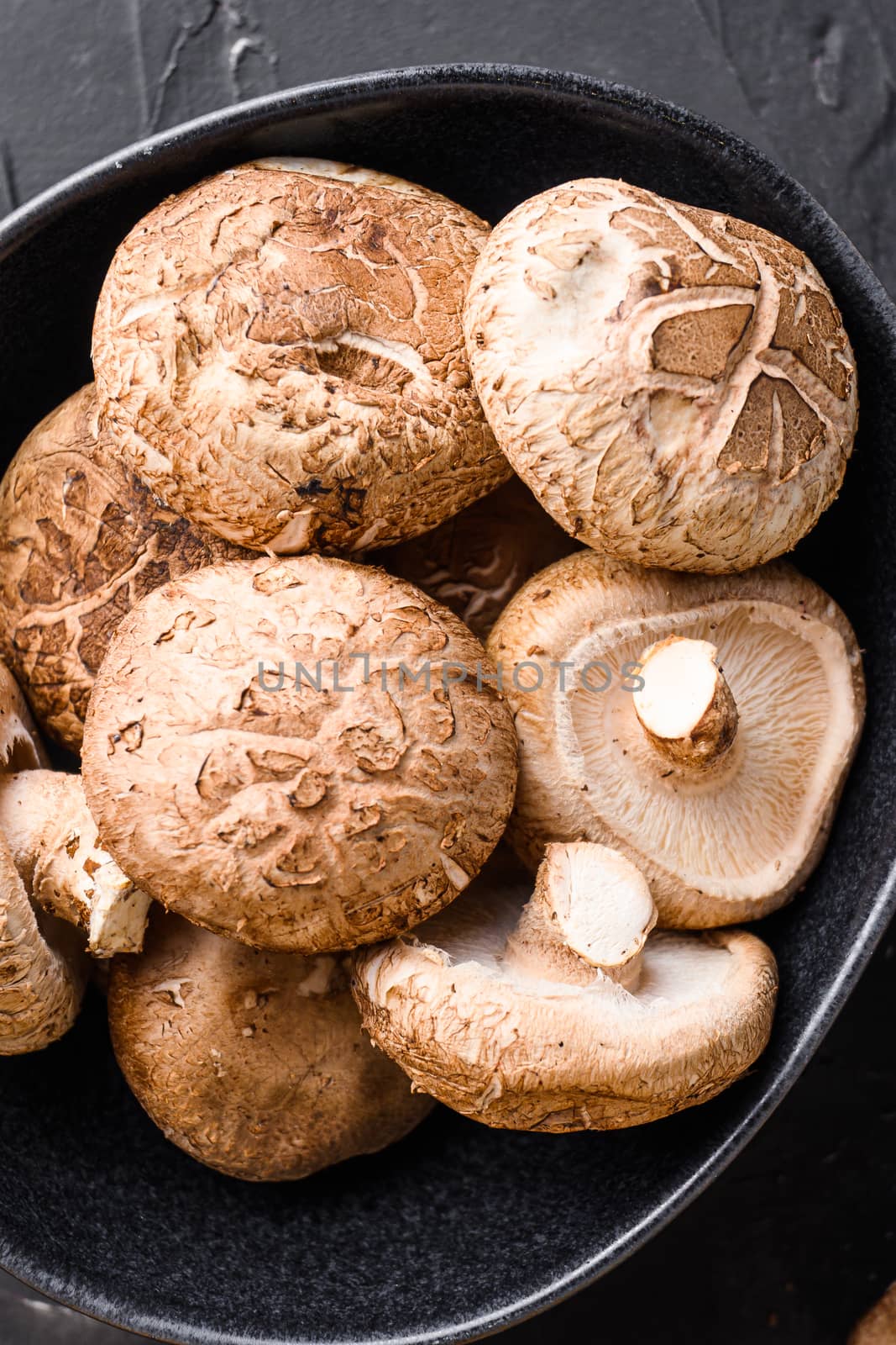 Shiitake mushrooms set on black background top view close up. by Ilianesolenyi