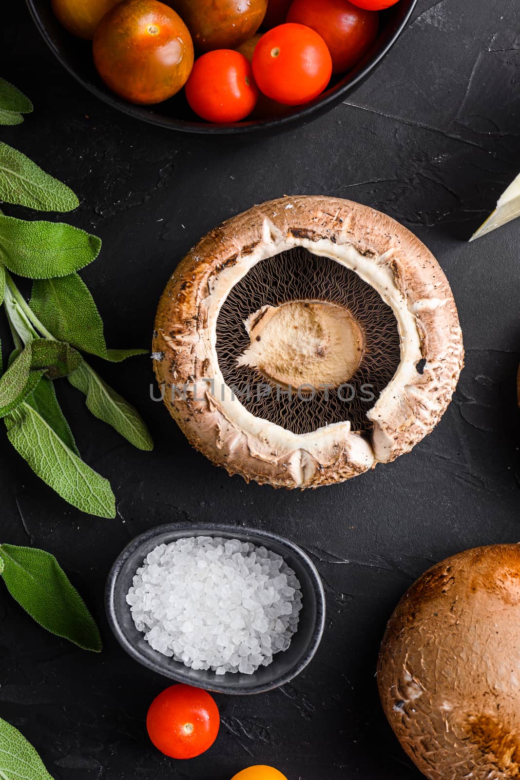 Portabello mushrooms ingredients for baking, cheddar cheese and sage on black background. top view. by Ilianesolenyi