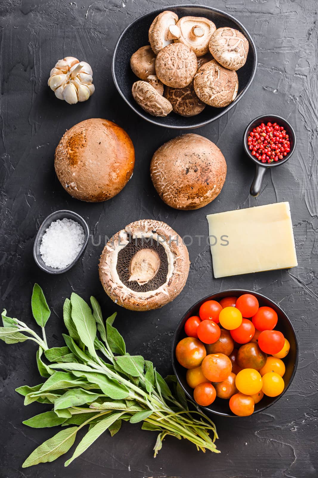 Garlicky mushrooms ingredients, portabello cheddar cheese and sage for baking on black background. Top view. by Ilianesolenyi