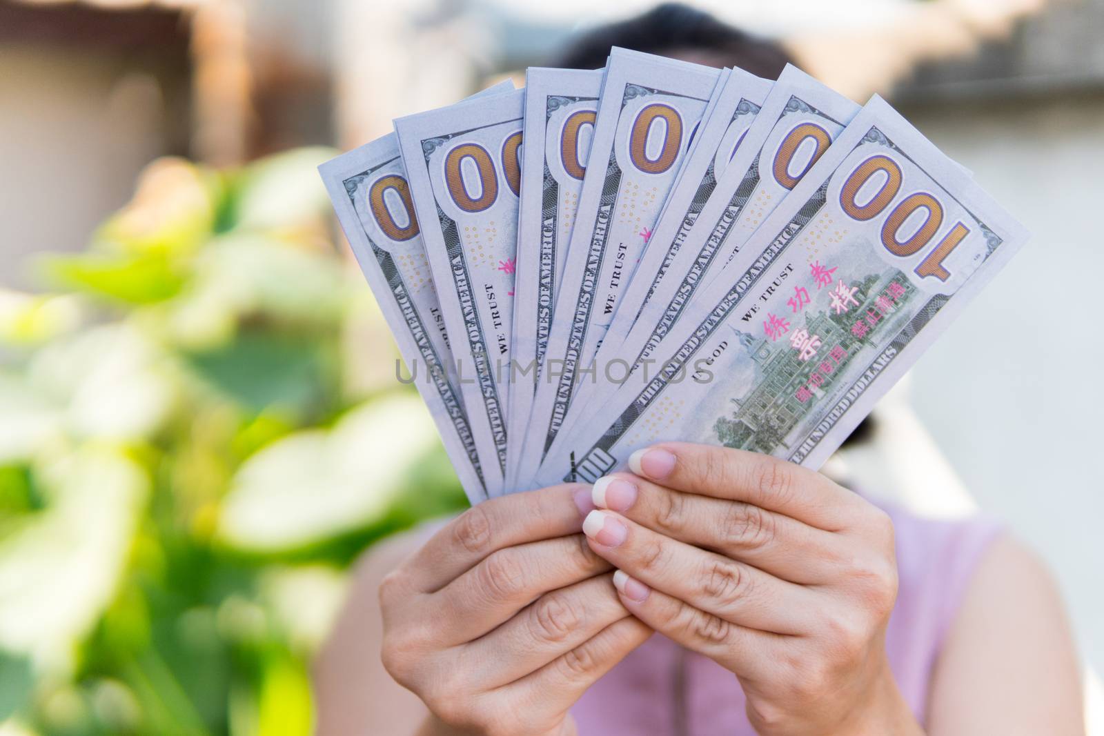 Women show hundreds of dollars in their hands