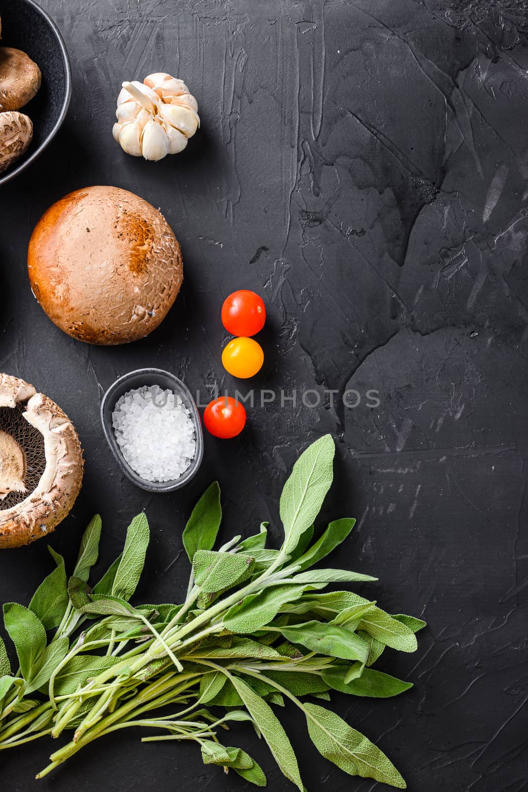 Portabello mushrooms ingredients for baking, cheddar cheese and sage on black background. Top view space for text. by Ilianesolenyi