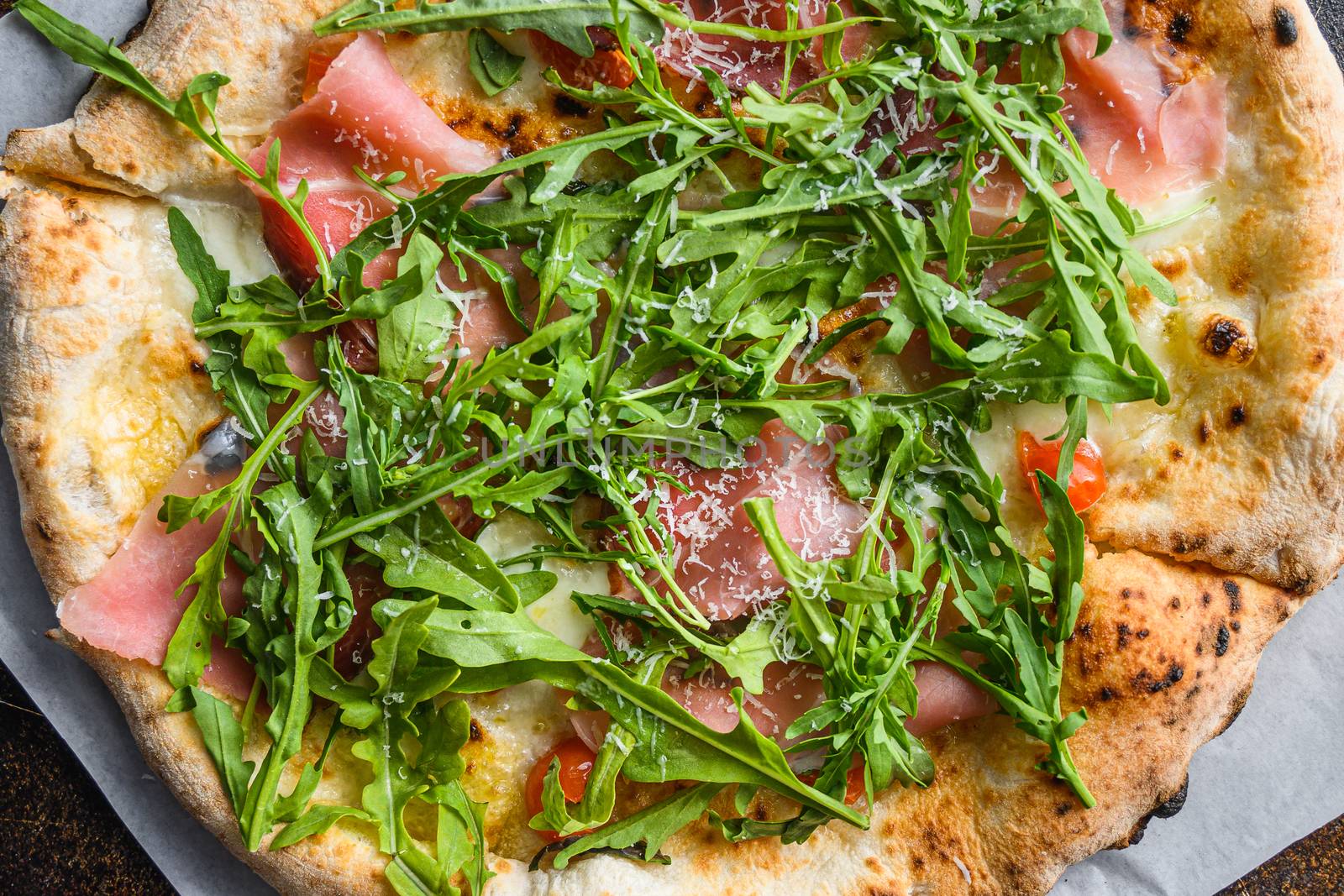 Italian pizza with mozzarella, cheese and basil leaves on old surface. Top view, close up