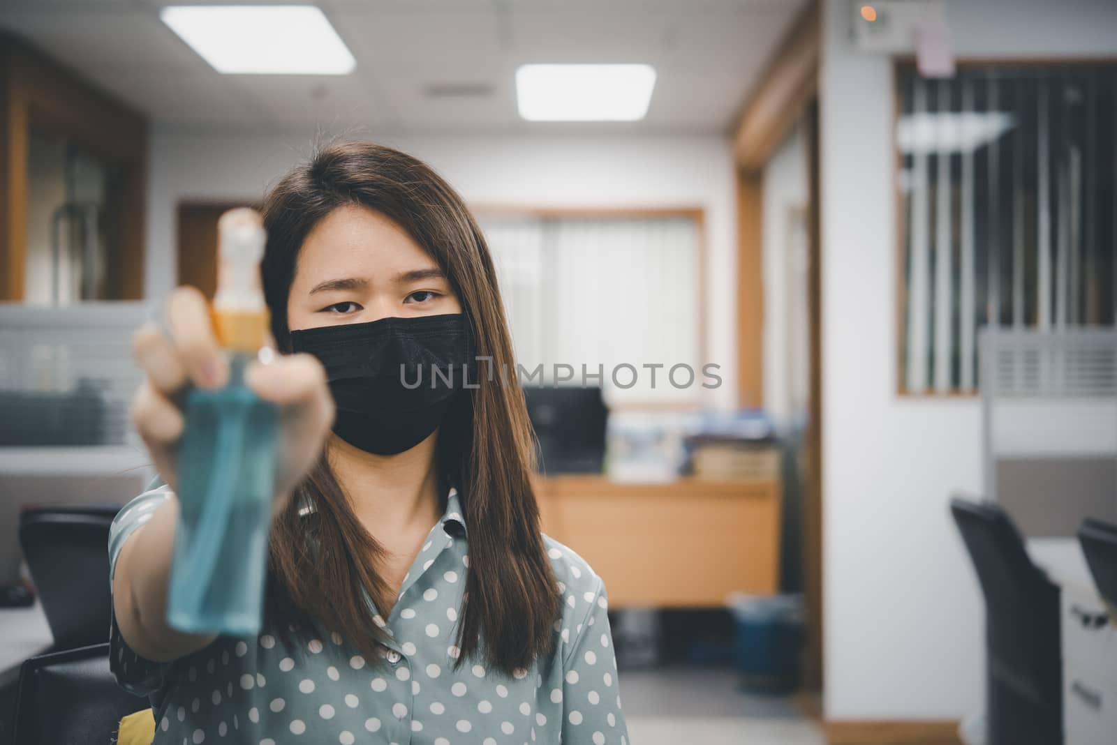 Asian woman wearing mask and alcohol antibacterial hand gel respiratory protection mask against epidemic flu covid19 or corona virus with fear emotion in concept illness, outbreak, healthcare in life