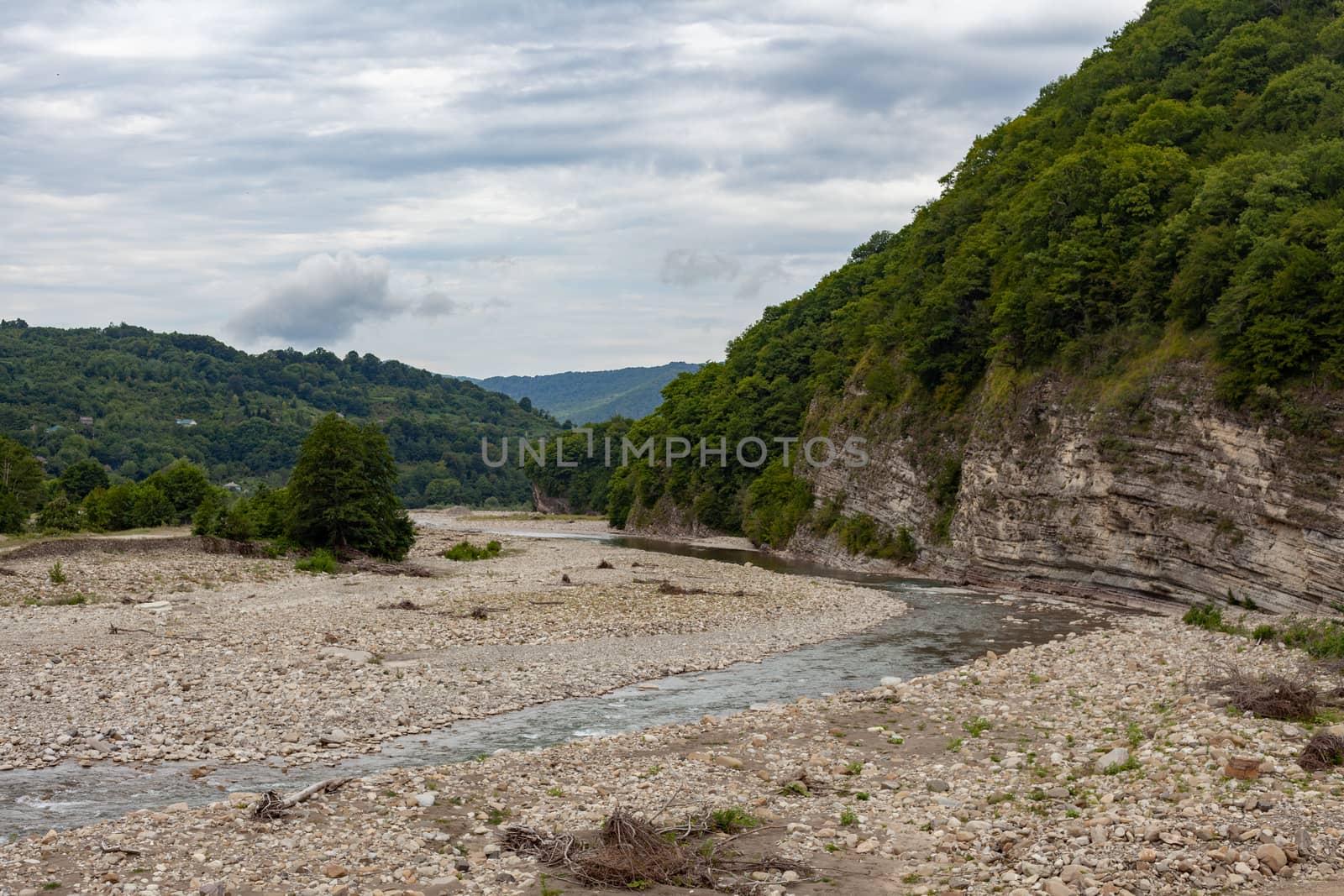 Mountain stonebed of river at the cloudy summer day