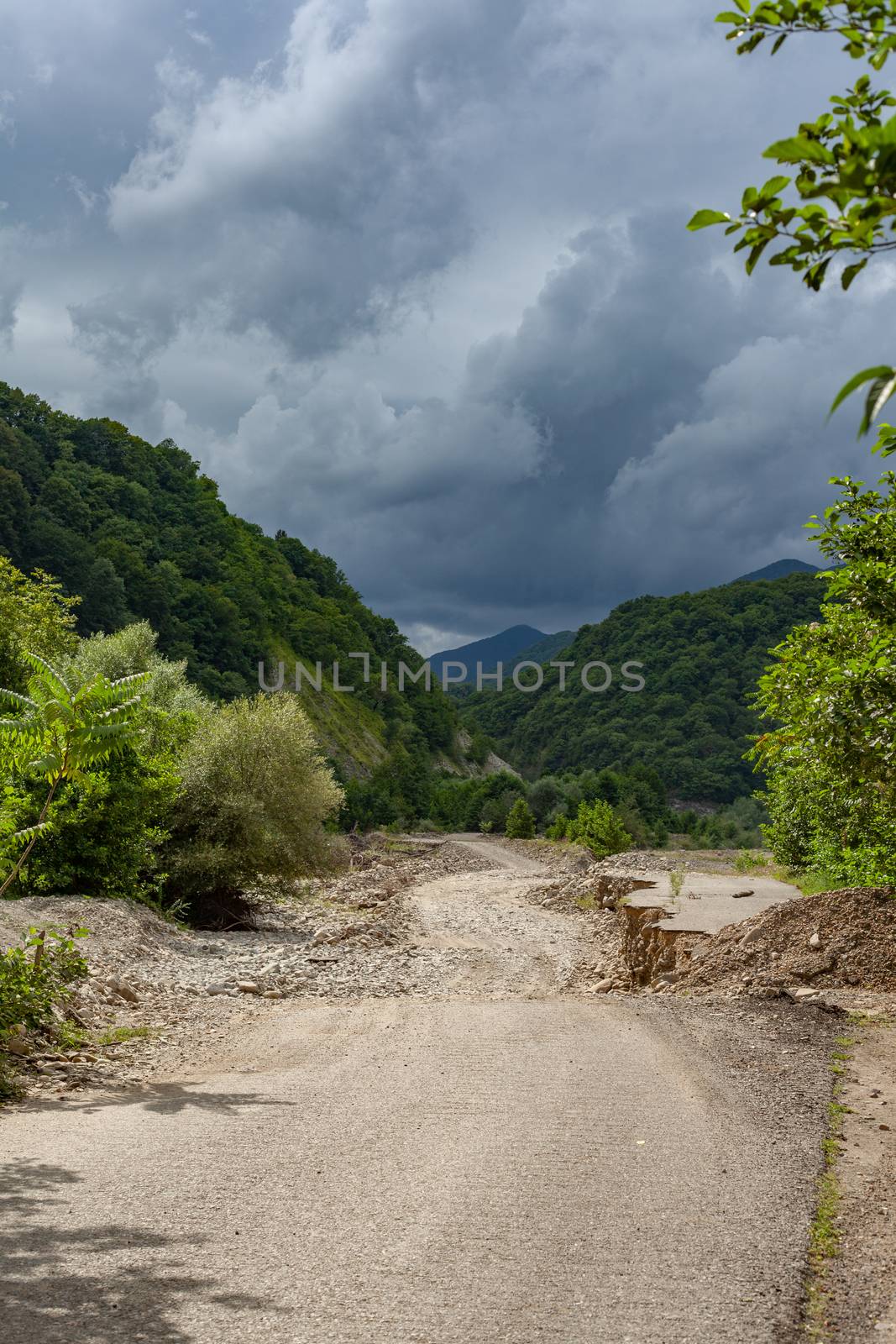 Dirt road in the stonebed of river Ashe at the summer day