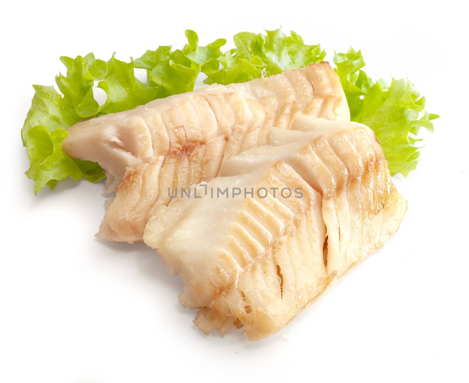 Two baked cod loin pieces with fresh green lettuce