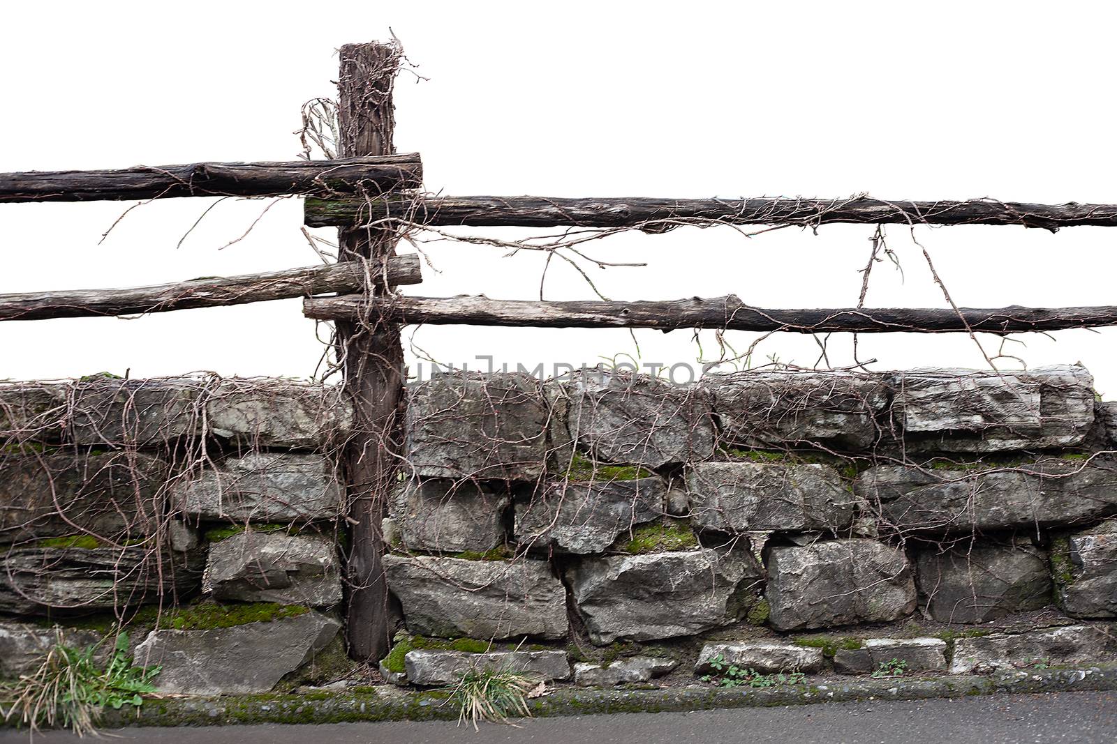 Fragment of stone and wooden fence at the spring