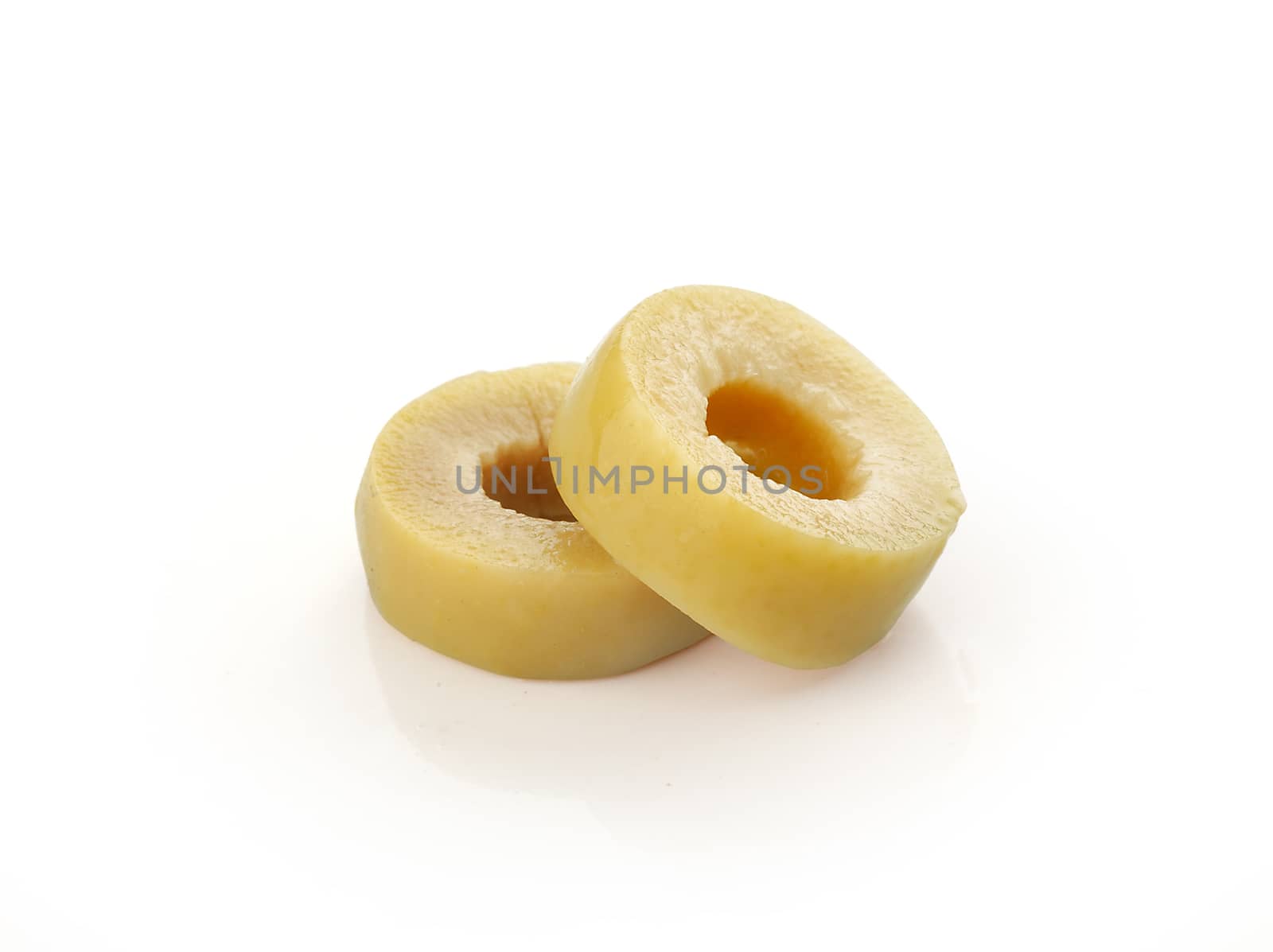 Isolated slices of green olives on the white background