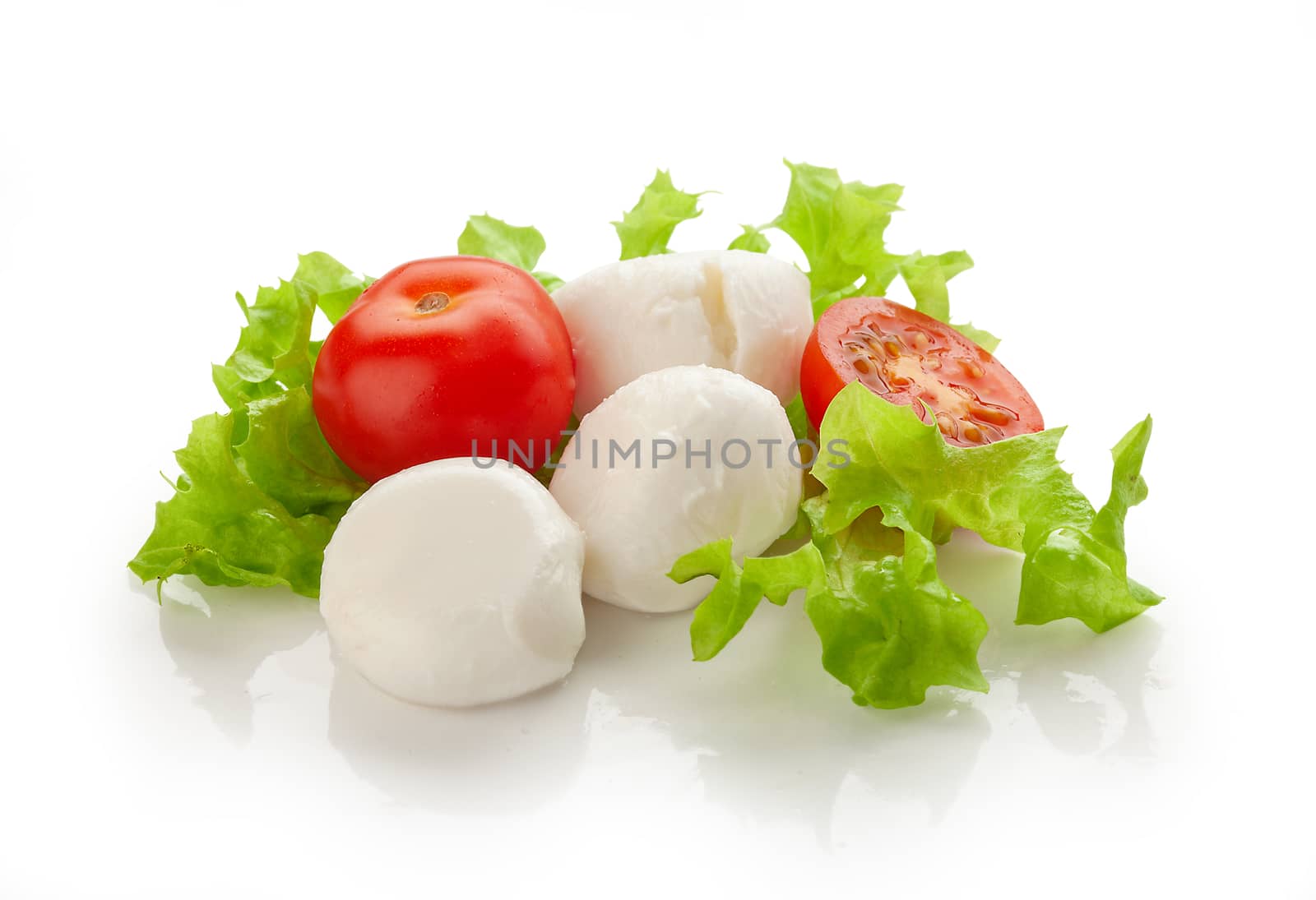 Small balls of Mozzarella with tomato cherry and fresh green lettuce