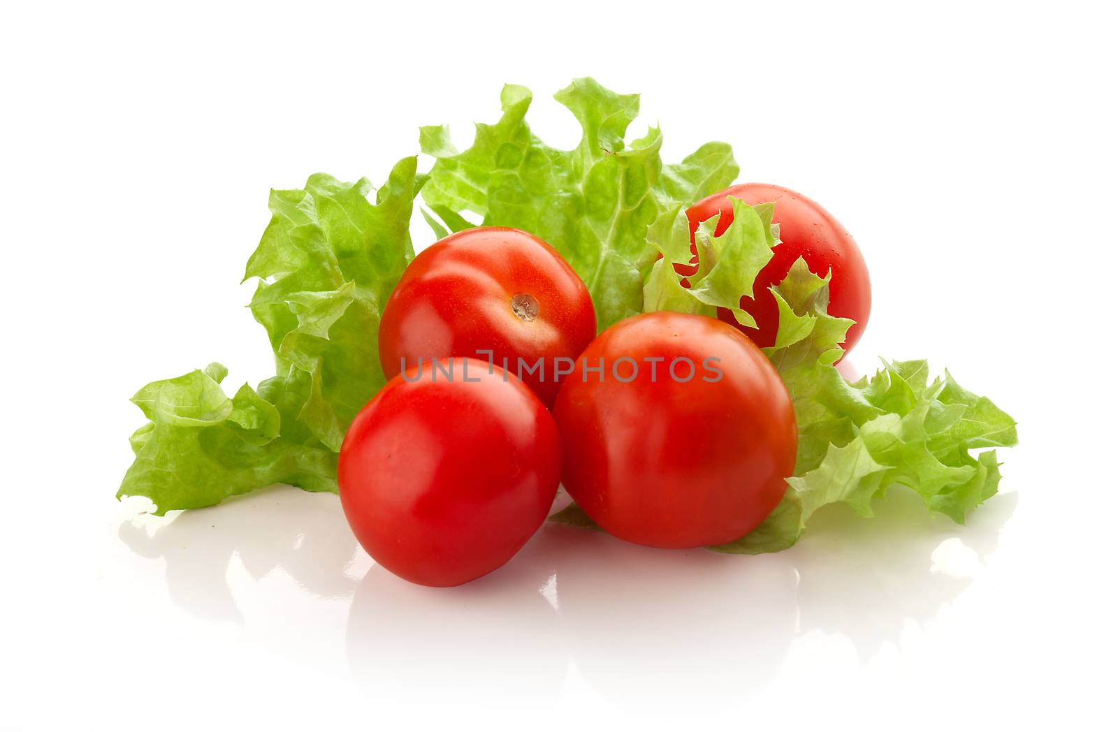 Some fresh red cherry tomatoes with green lettuce