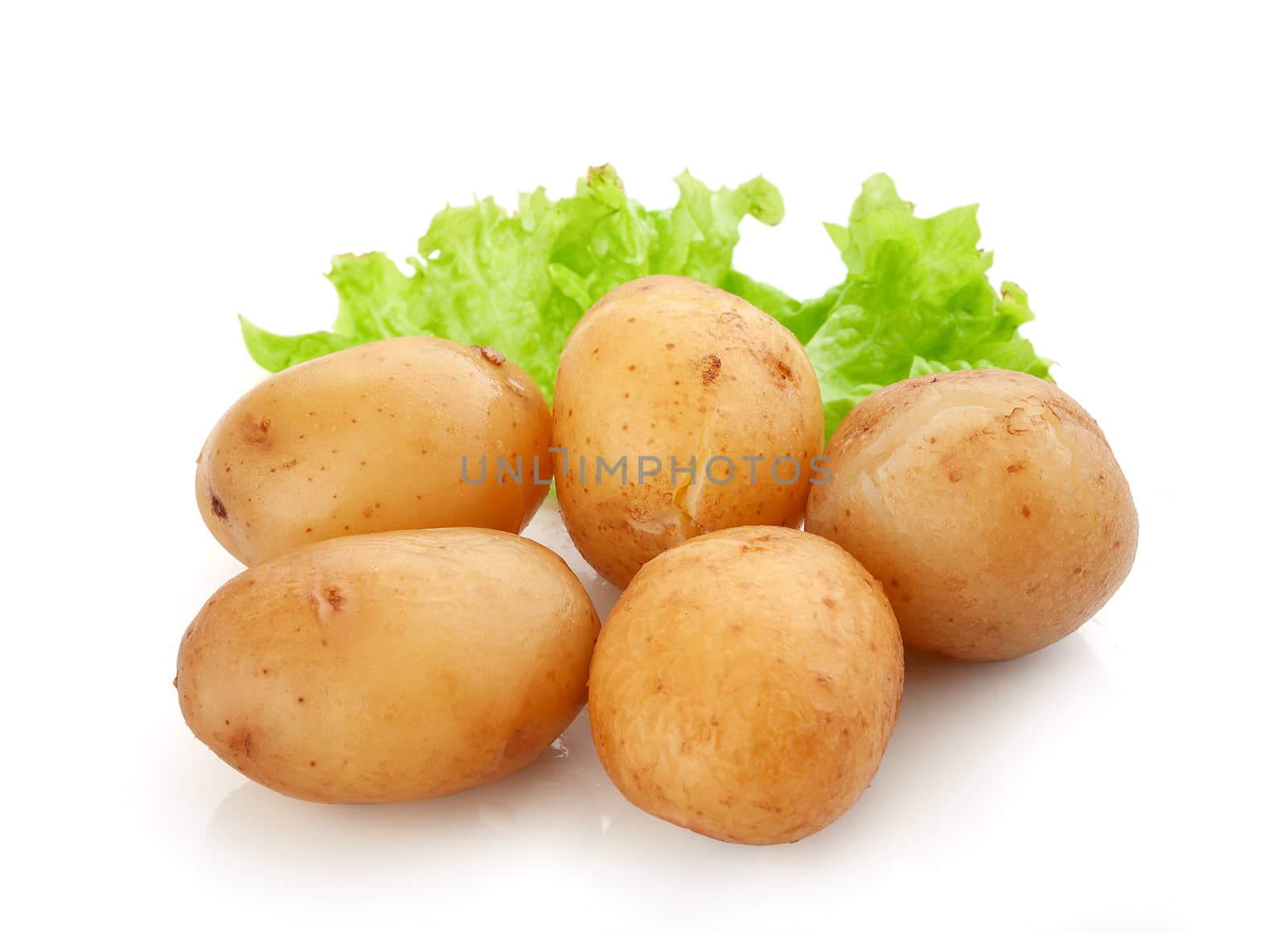 Isolated heap of jacket potatoes with fresh green lettuce