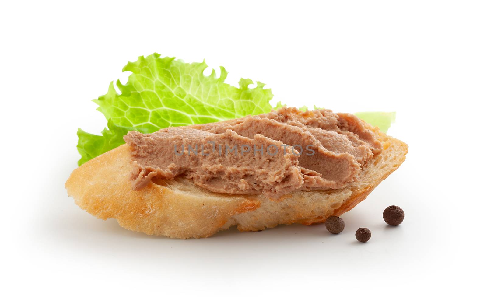 Isolated sandwich with meat pate, lettuce and black pepper