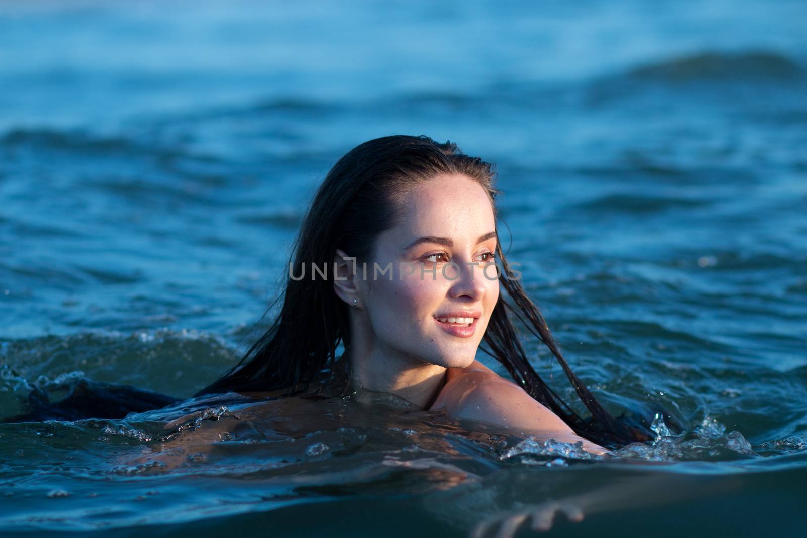 woman swimming in the sea smiling sexy by timwit