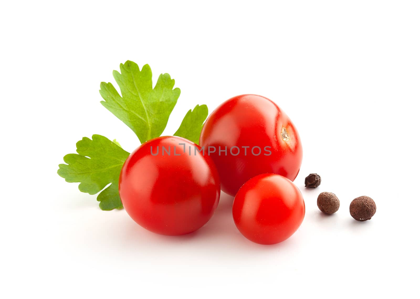 Three small tomatoes with fresh parsley and black pepper