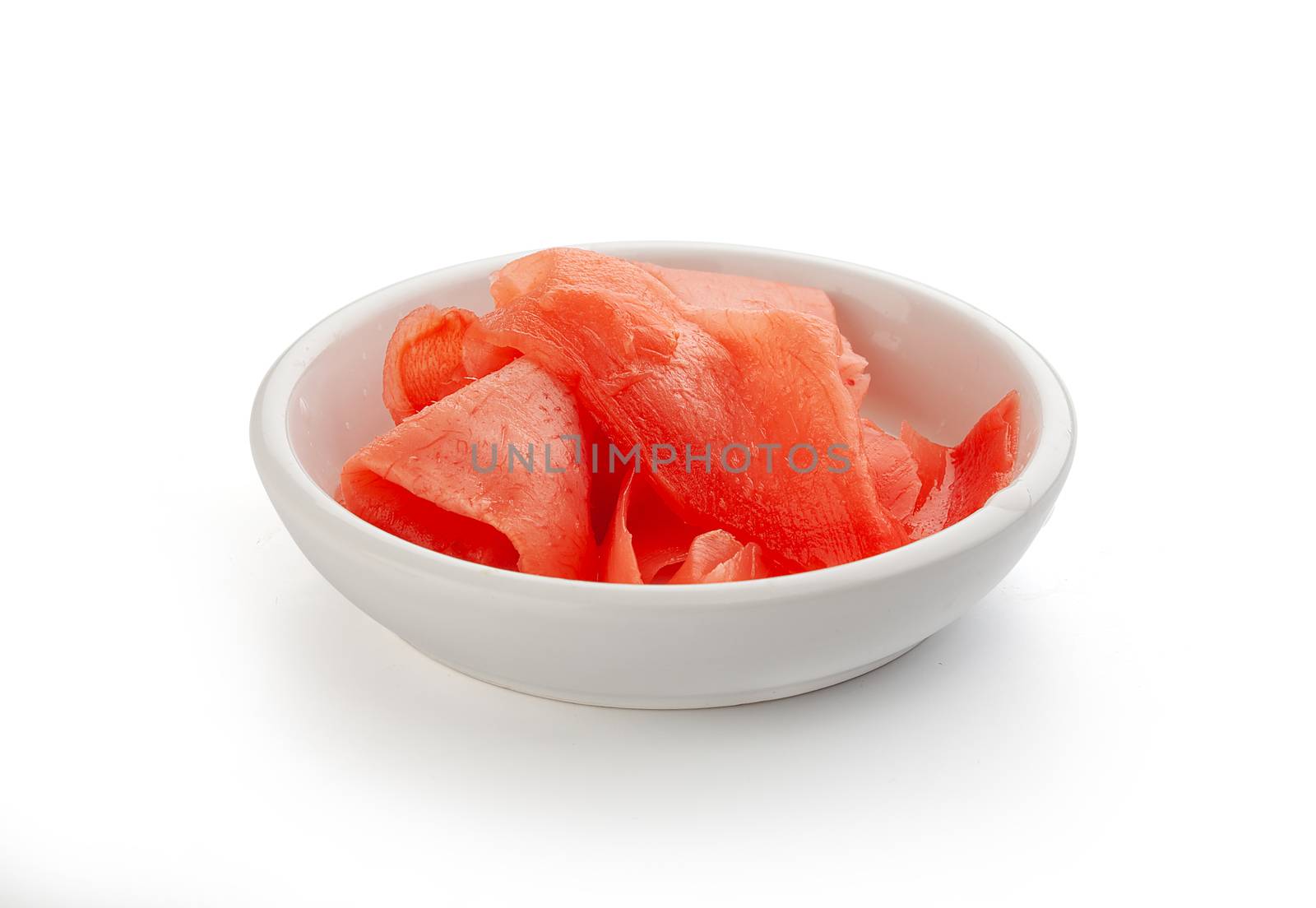 Isolated red pickled ginger in the white bowl