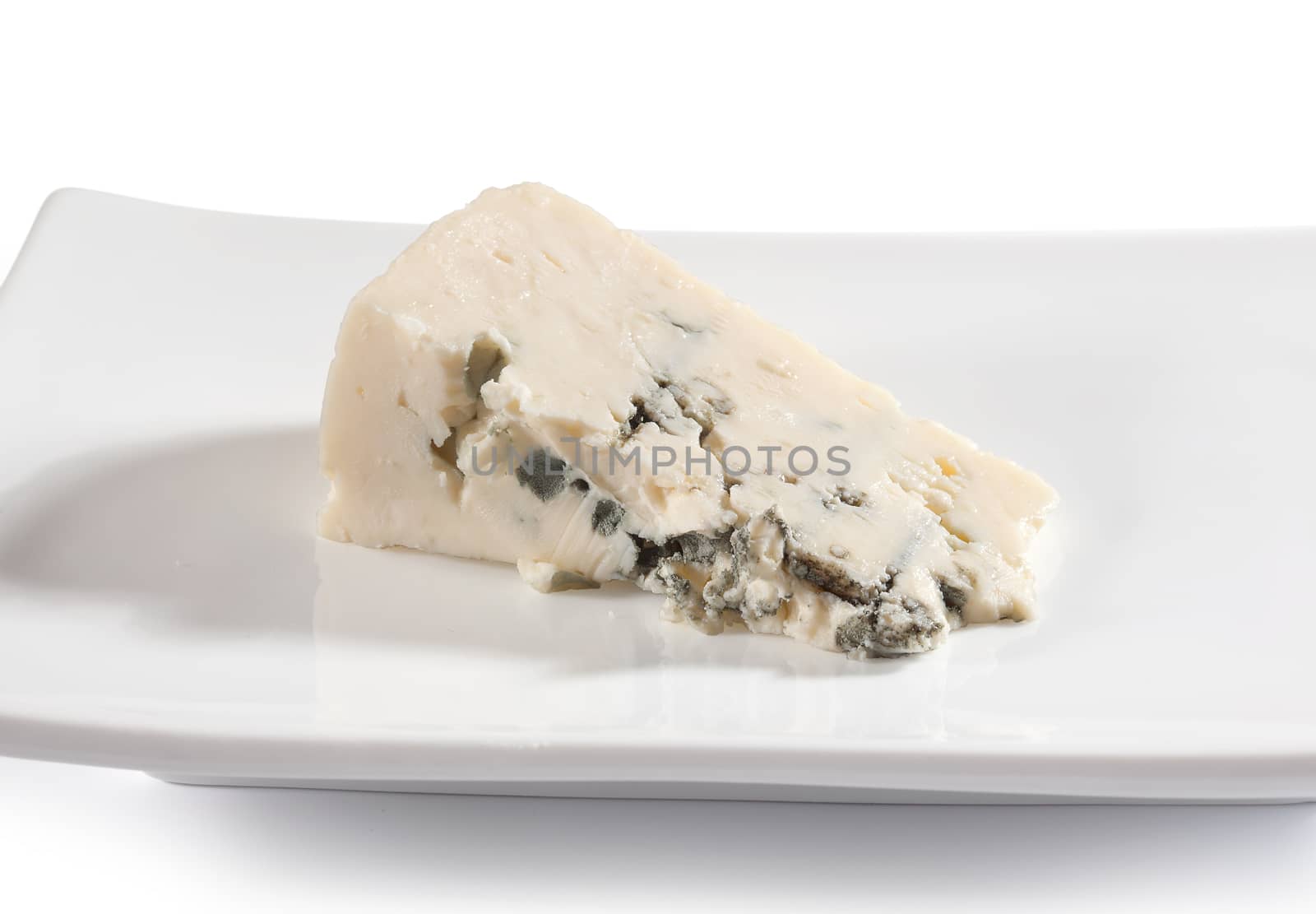 Piece of blue cheese on the white plate