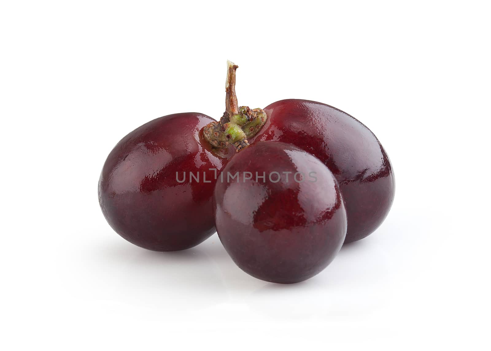 Isolated three berries of red grape on the white background