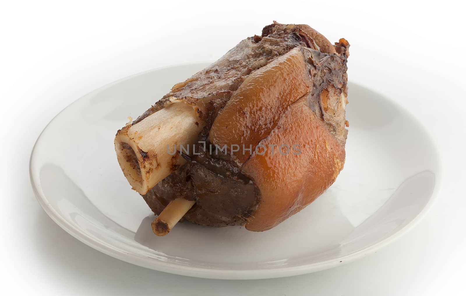 Roasted pork knuckle on the white plate