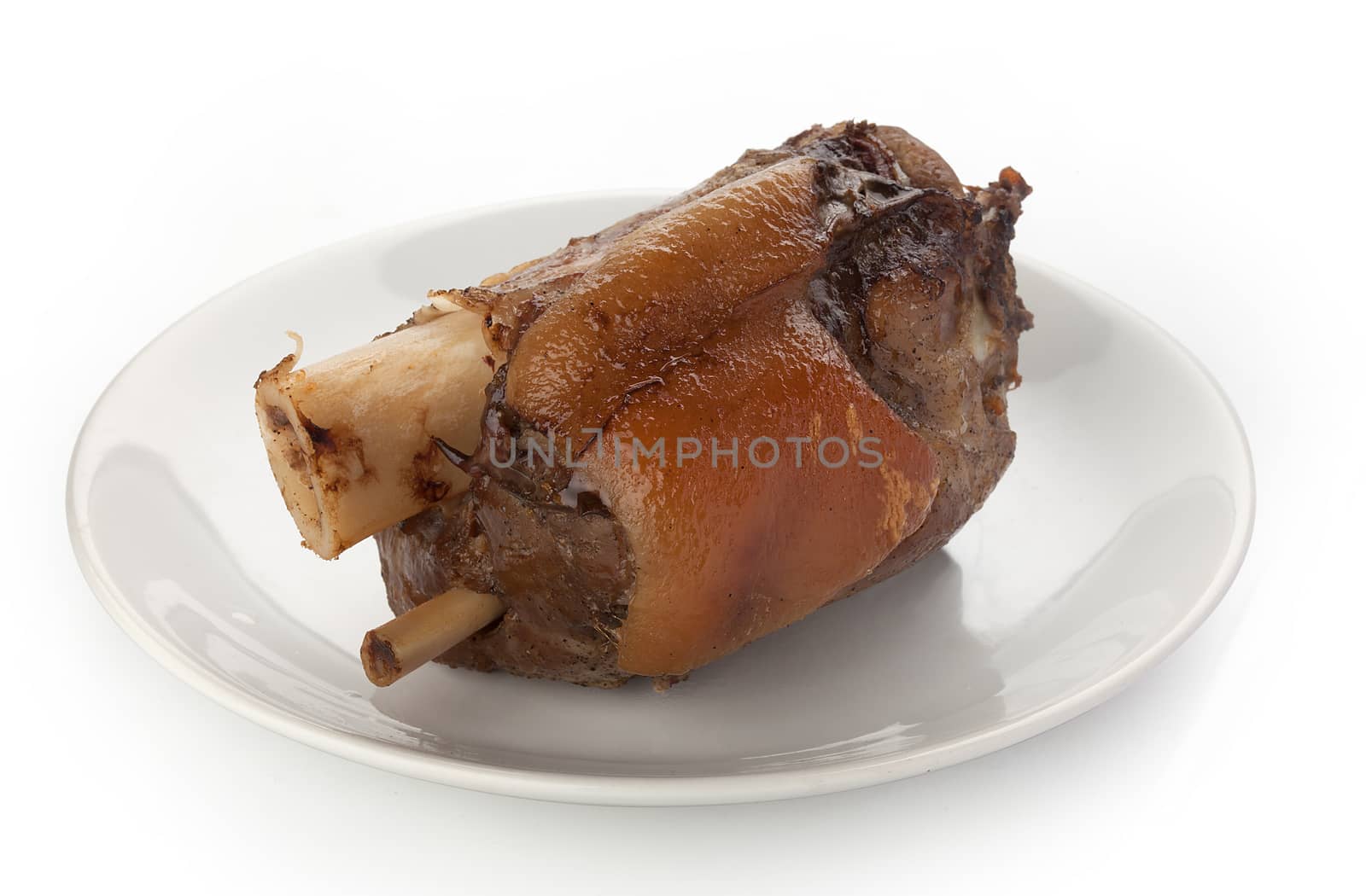 Roasted pork knuckle on the white plate