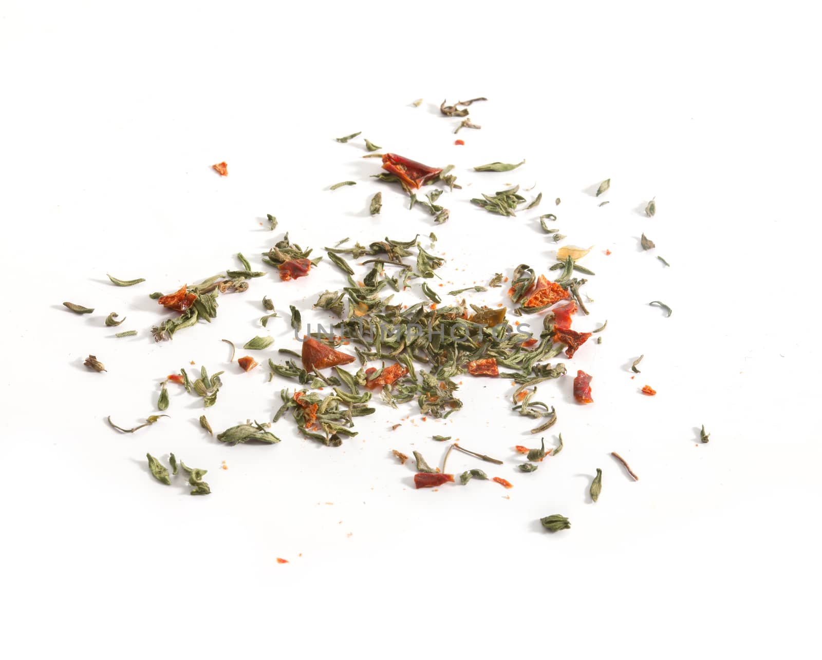 Dried red and green herbs on the white background