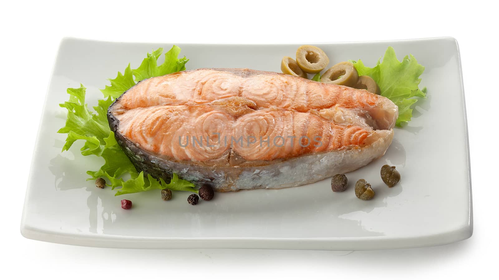 Baked steak of salmon with olives, capers, lettuce and black peppers