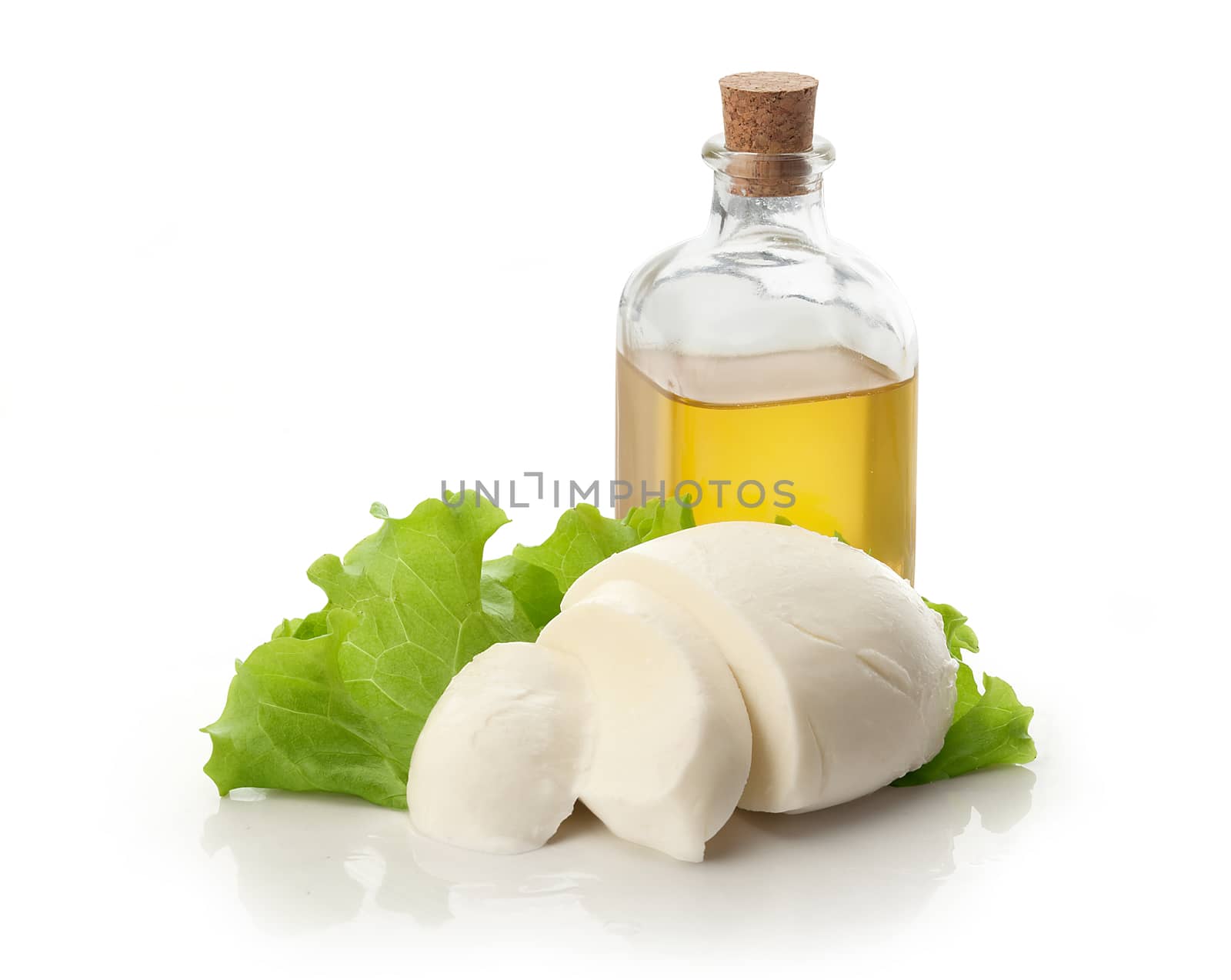 Sliced mozzarella ball white lettuce and olive oil on the white