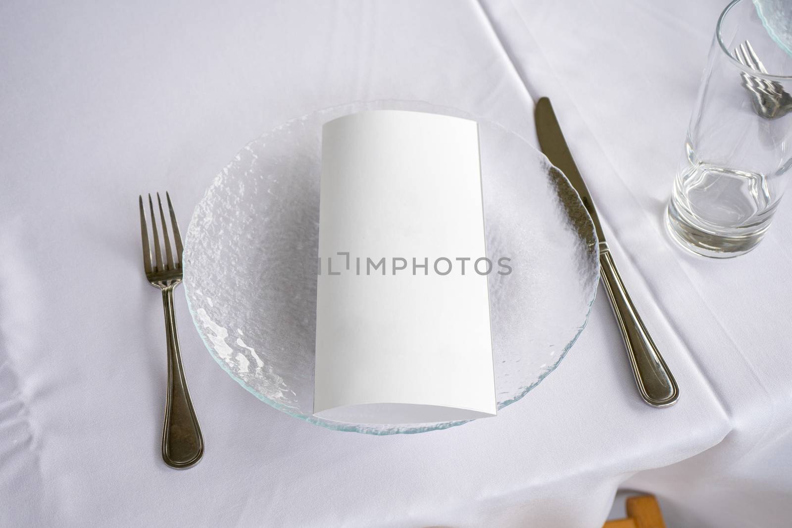 table setting transparent plate fork knife and invitation