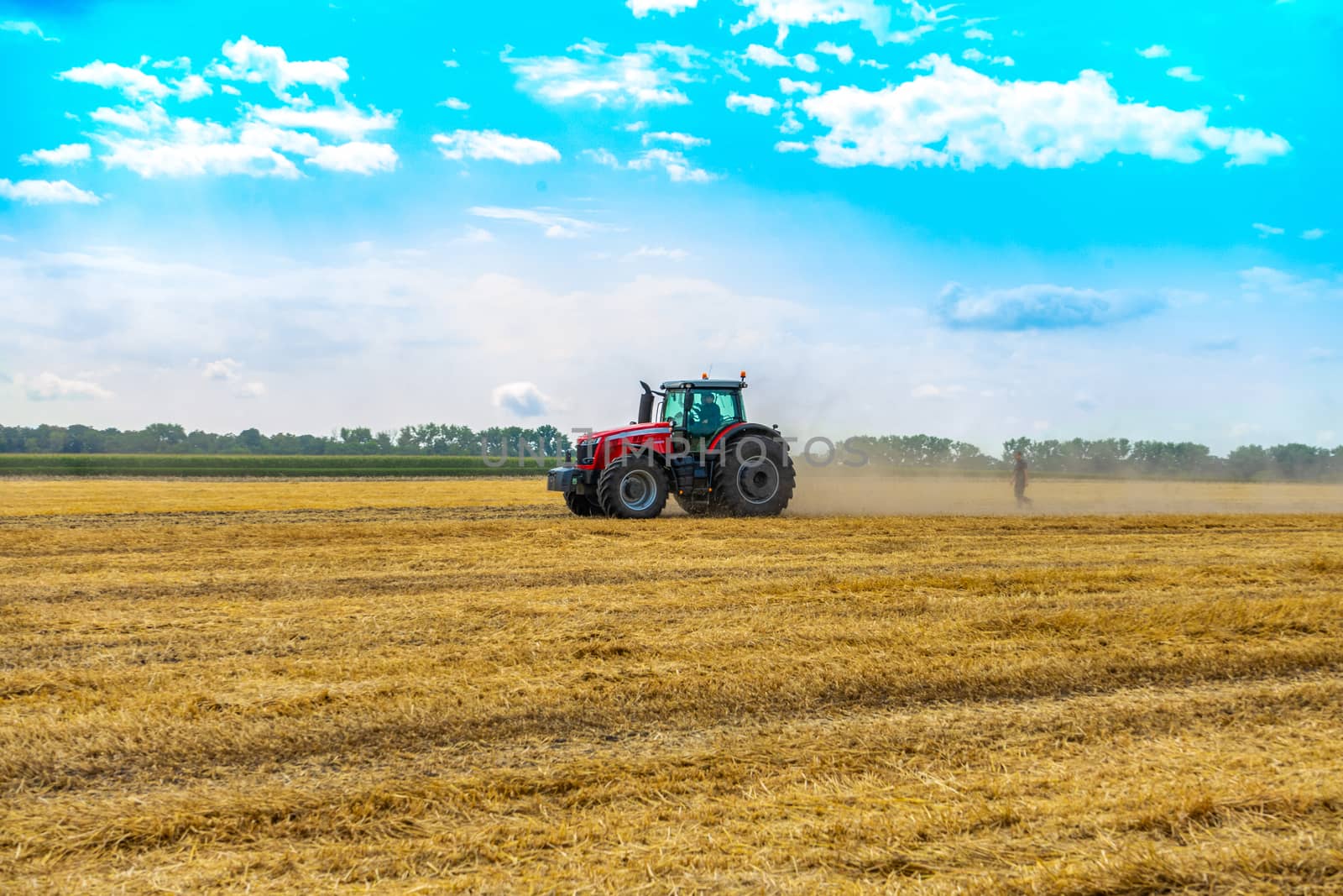 tractor with sprayer drives across the field