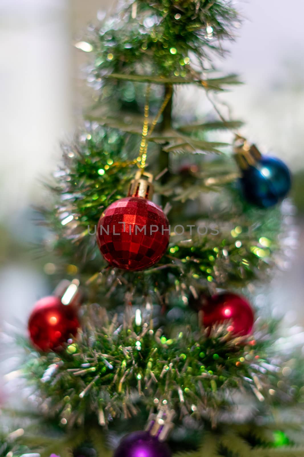 bright Christmas balls on a decorative small Christmas tree