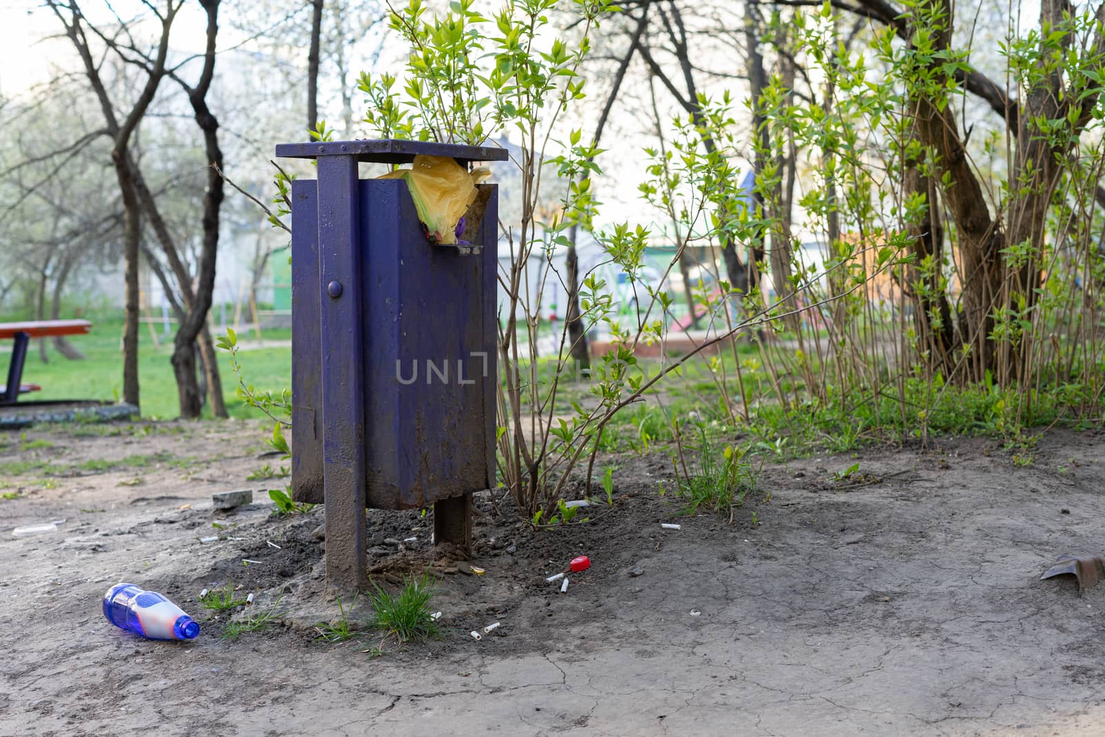 Full trash can and bottle on the ground by Serhii_Voroshchuk