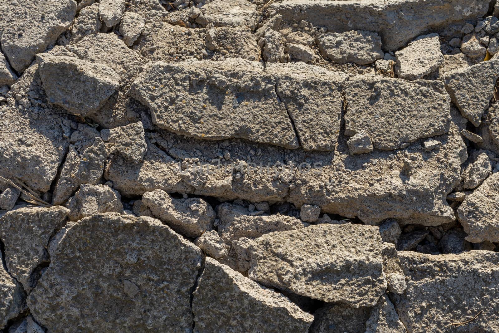 broken concrete and asphalt on the road by Serhii_Voroshchuk