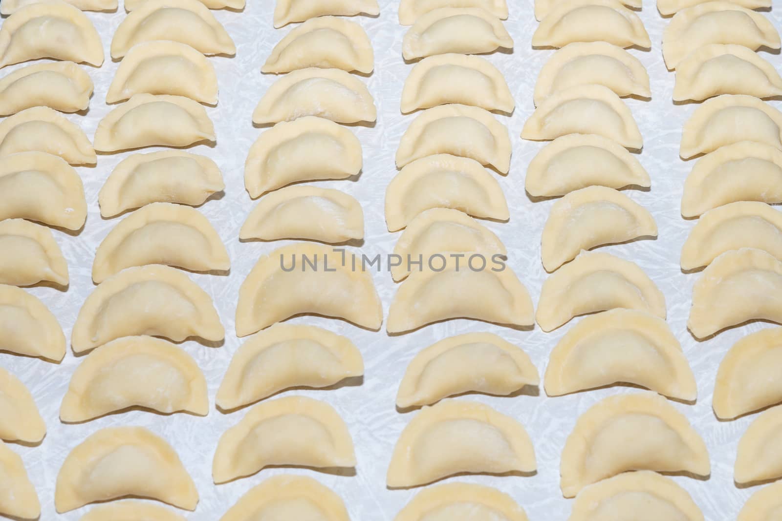 homemade delicious handmade dumplings are dusted with flour and await cooking