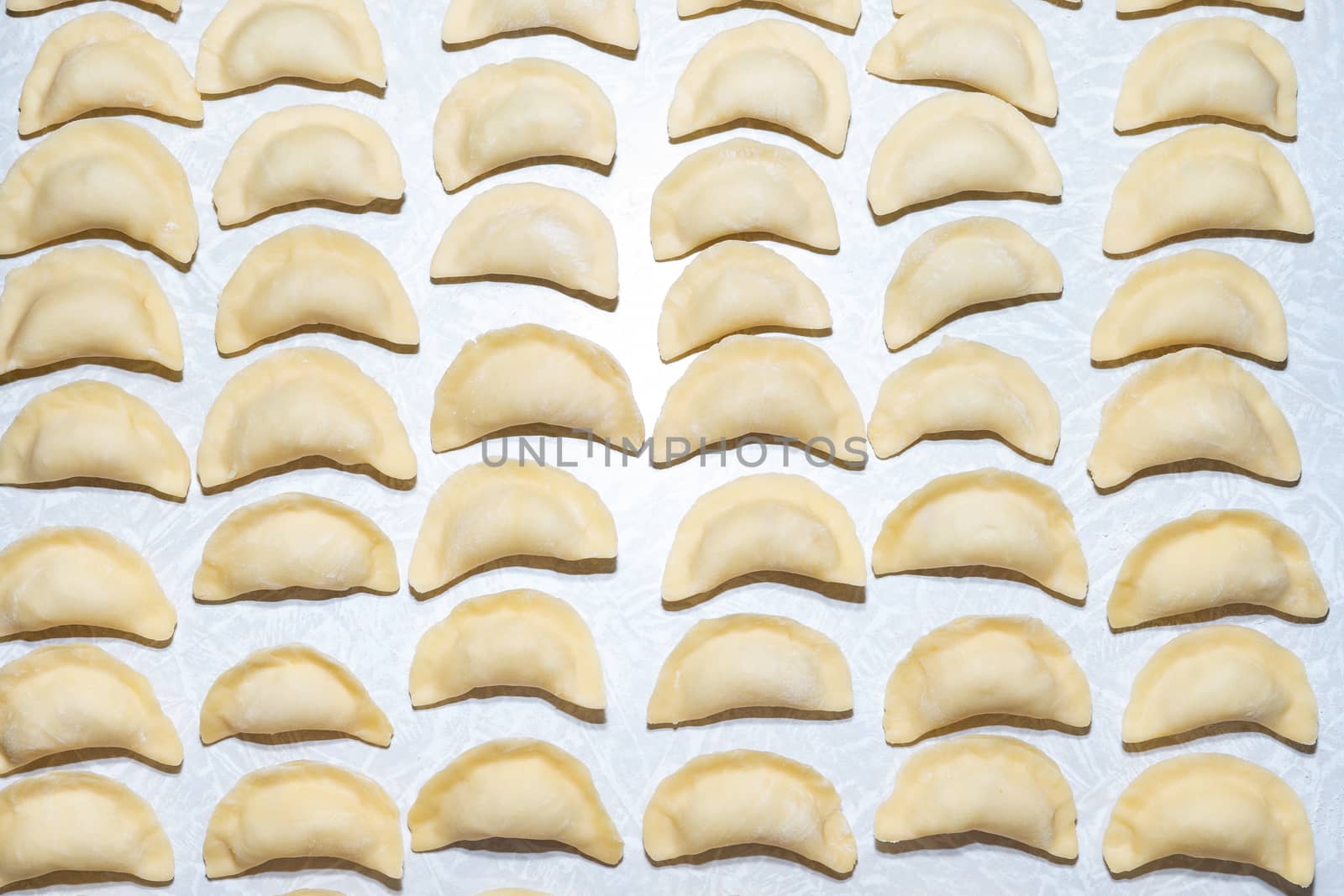 homemade delicious handmade dumplings are dusted with flour and await cooking