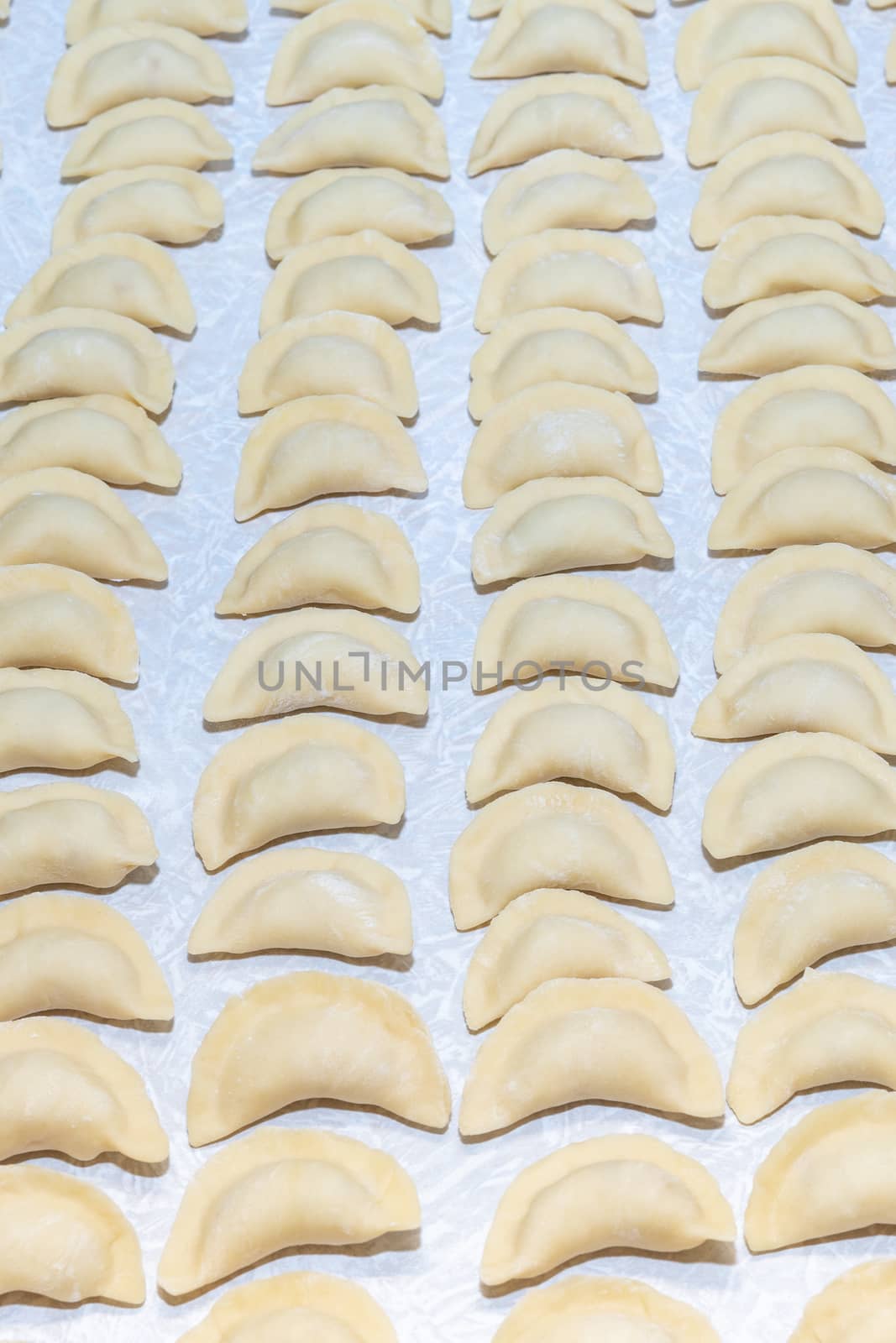 homemade delicious handmade dumplings are dusted with flour and await cooking