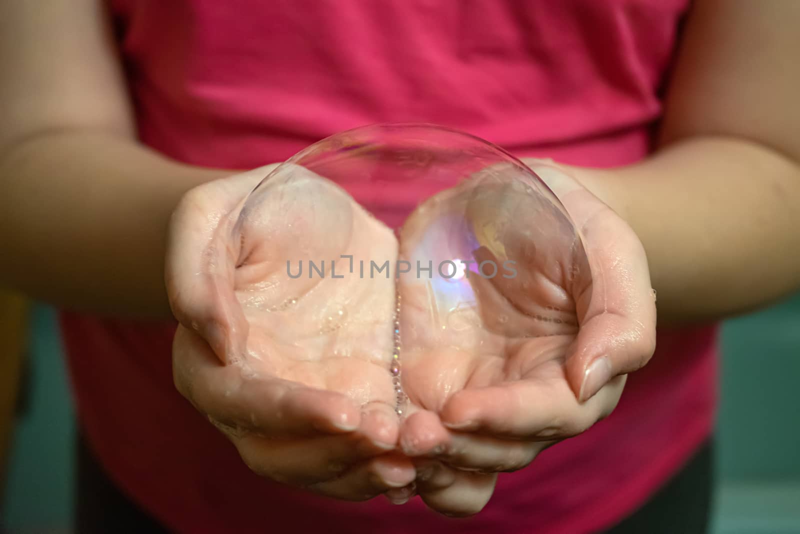 in the hands of the baby a big soap bubble