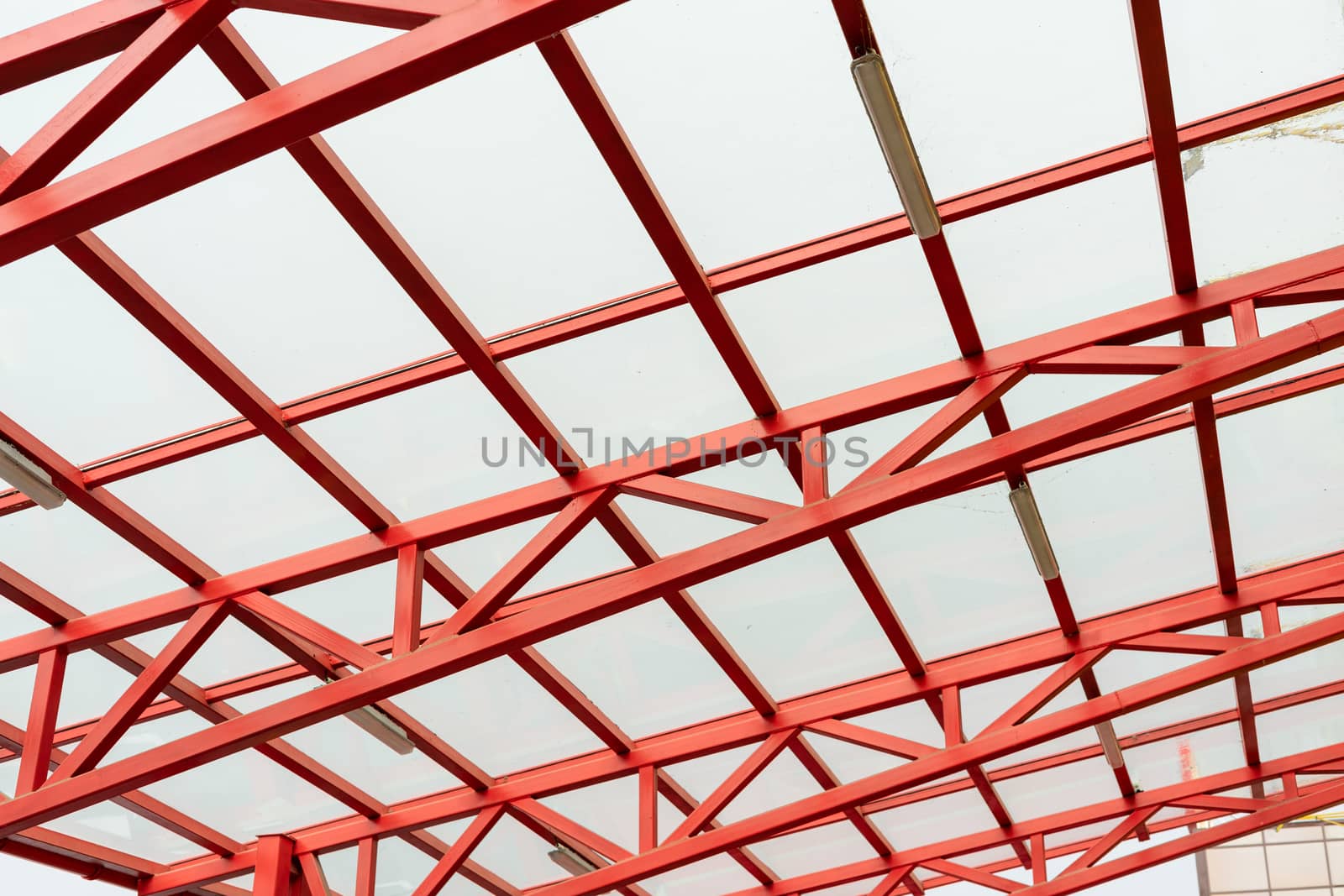 red metal construction holds a transparent roof