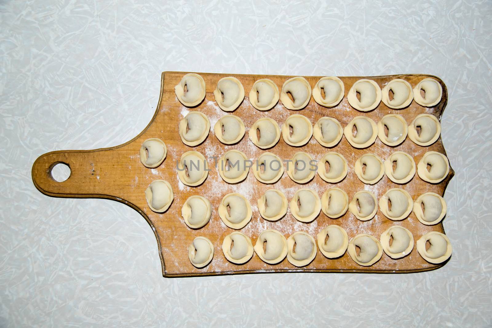 dumplings on a plate ready for cooking by Serhii_Voroshchuk