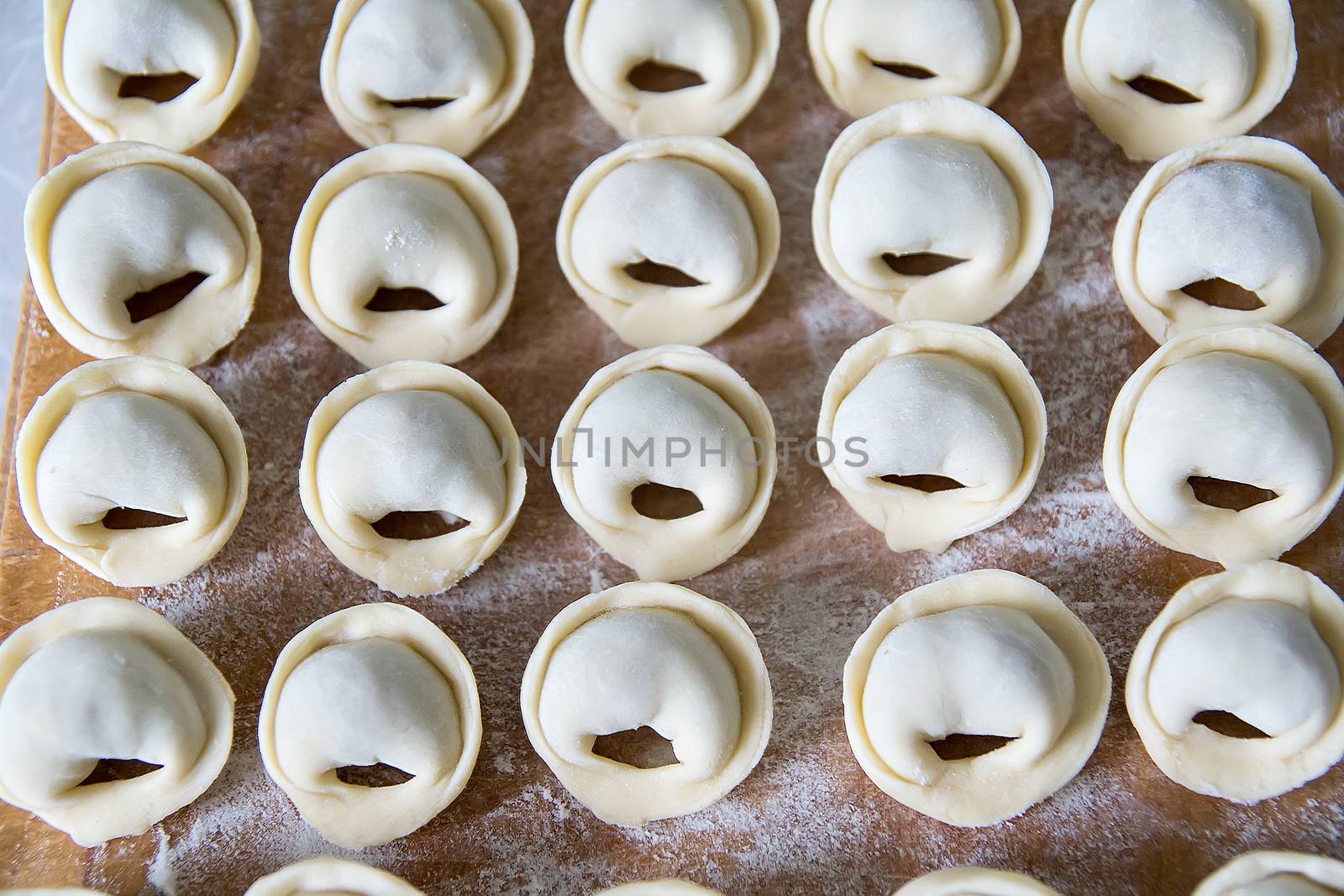 dumplings on a plate ready for cooking by Serhii_Voroshchuk