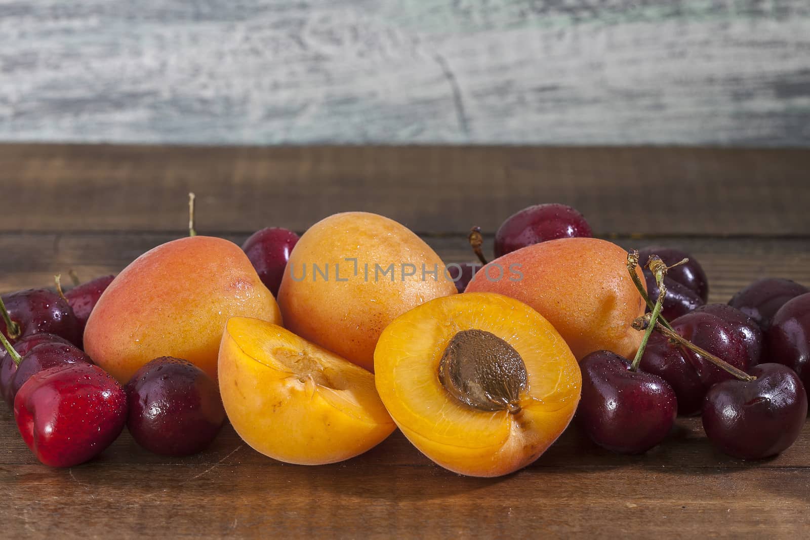 Apricot and cherries on the wooden rustic looking table