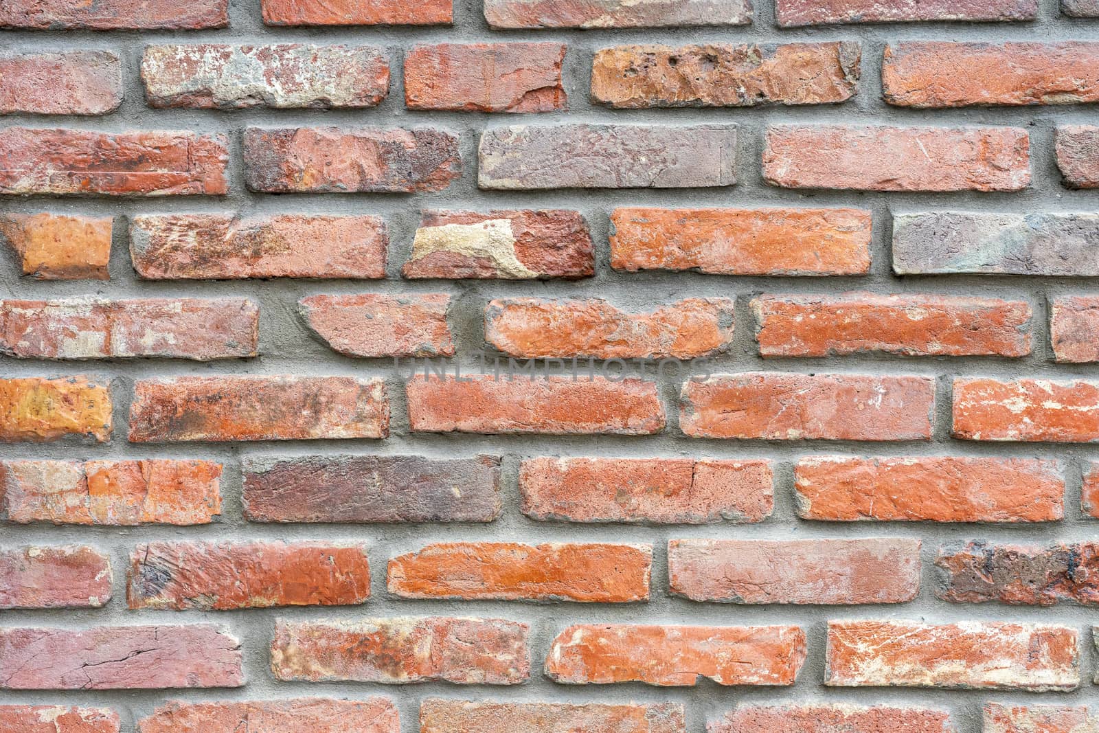 Ancient wall made of darkened red brick