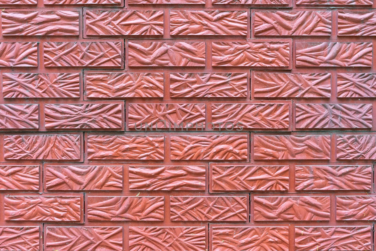 The wall is lined with red tiles with a brick texture