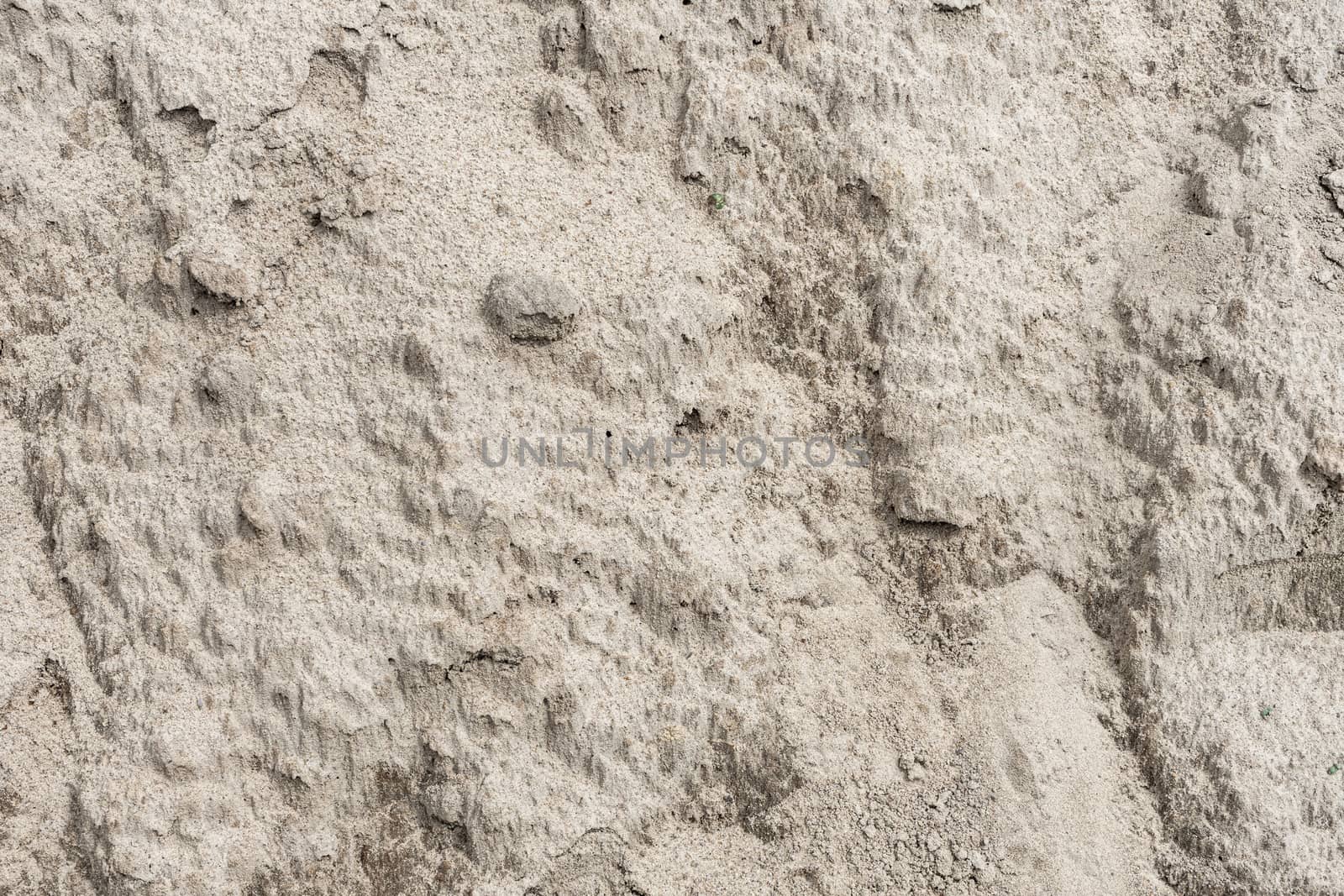 Crust on the dried sand after a downpour . Dried sand