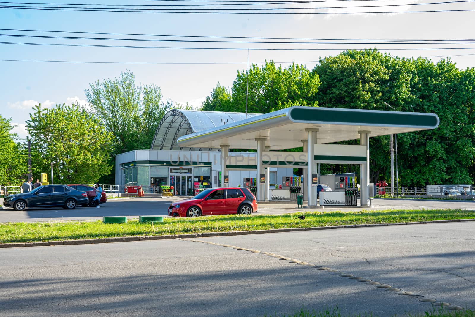 Vinnytsia, Ukraine - May 2020.  Car refueling near the road with cars and people